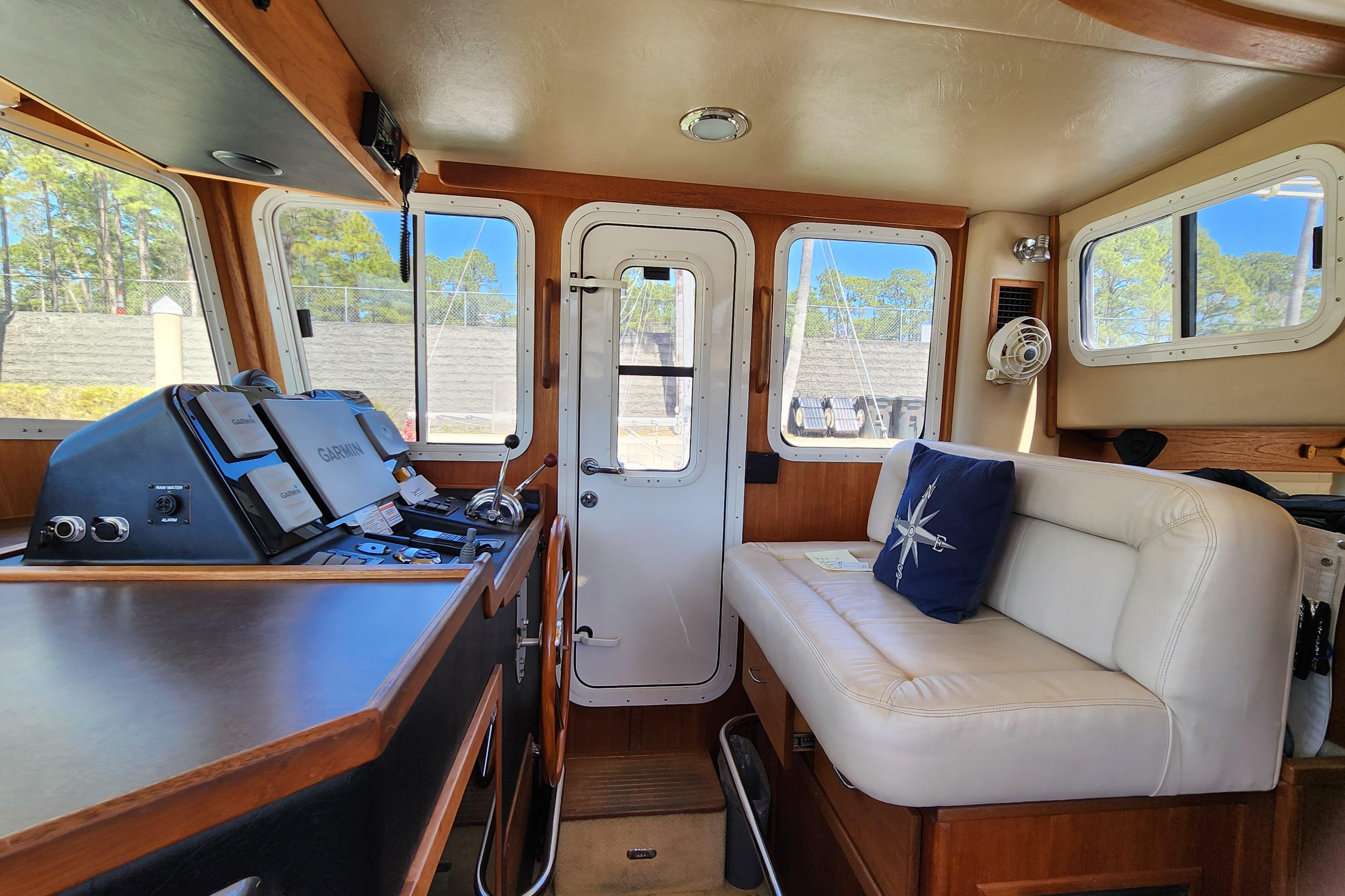 Interior of 2006 American Tug AT with navigation equipment and comfortable seating.