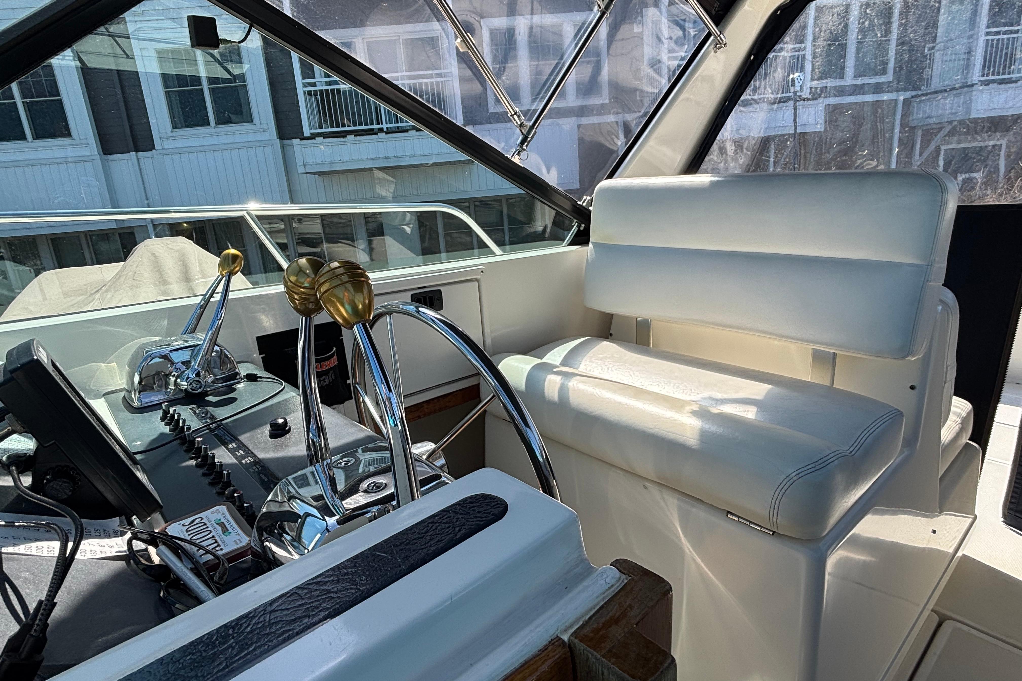 Interior of a 1991 Tiara Yachts 3100 Open, featuring helm controls and seating.