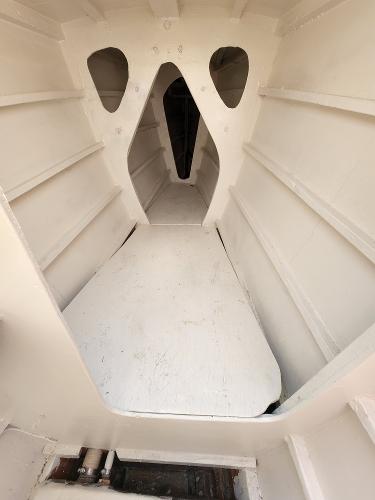 Interior view of 1985 Crowther Buccaneer boat, showcasing white cabin structure and design.