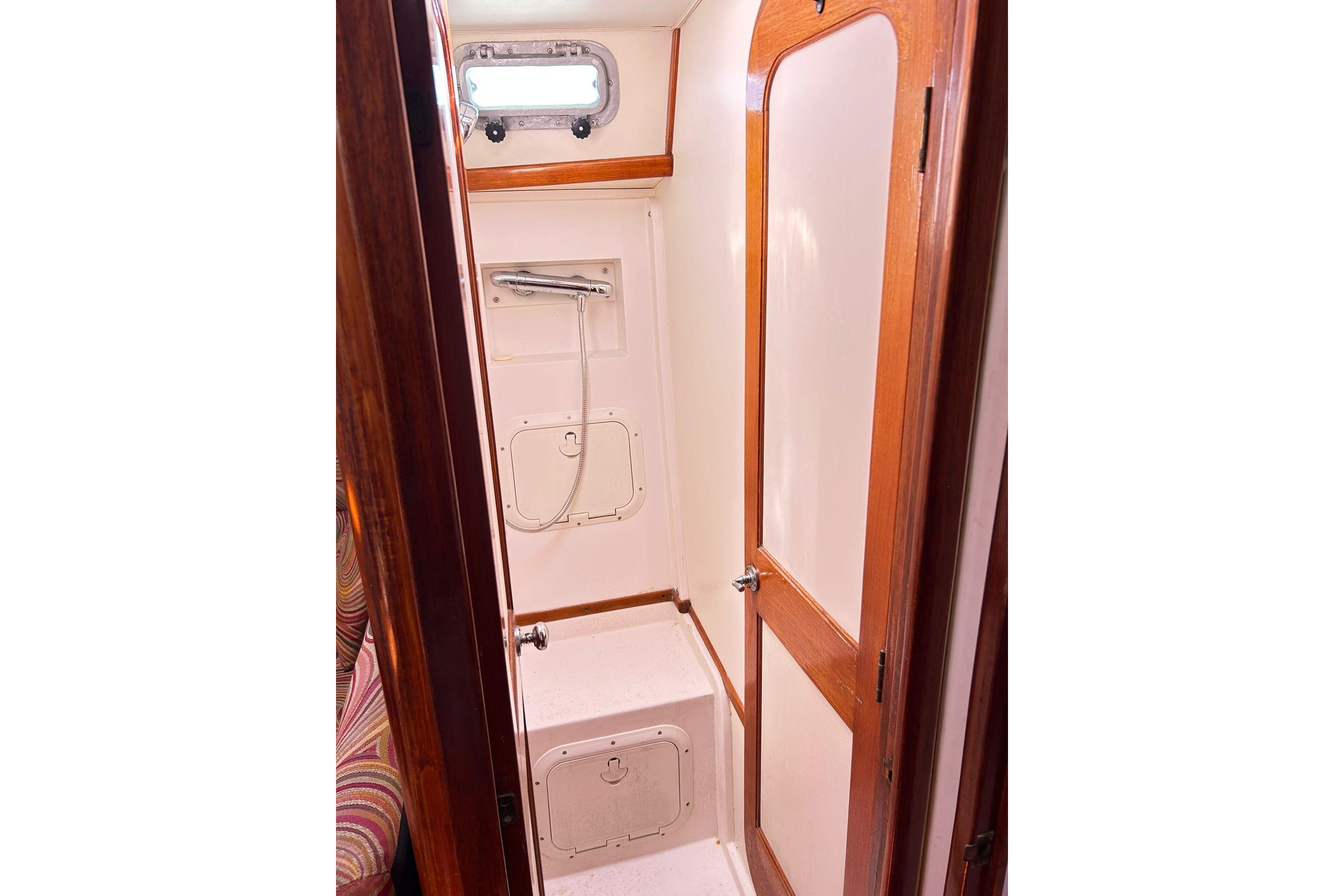 1987 Gulfstar CSY 50 Pilot House shower area with wooden trim and compact design.