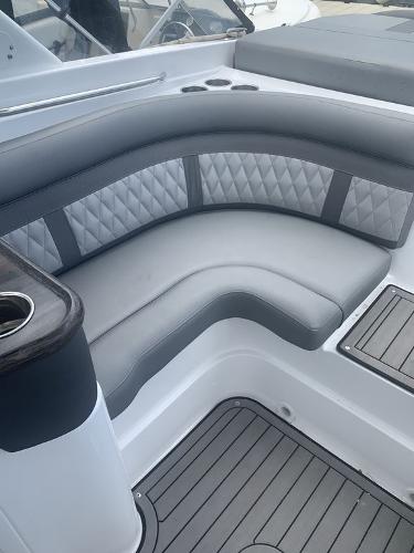 2020 Rinker 29QX BR boat interior with gray cushioned seating.