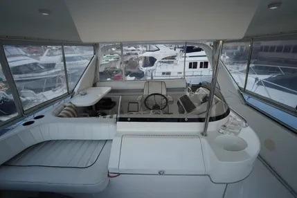 1994 Sea Ray 44 Express Bridge cockpit with helm, seating, and marina view.