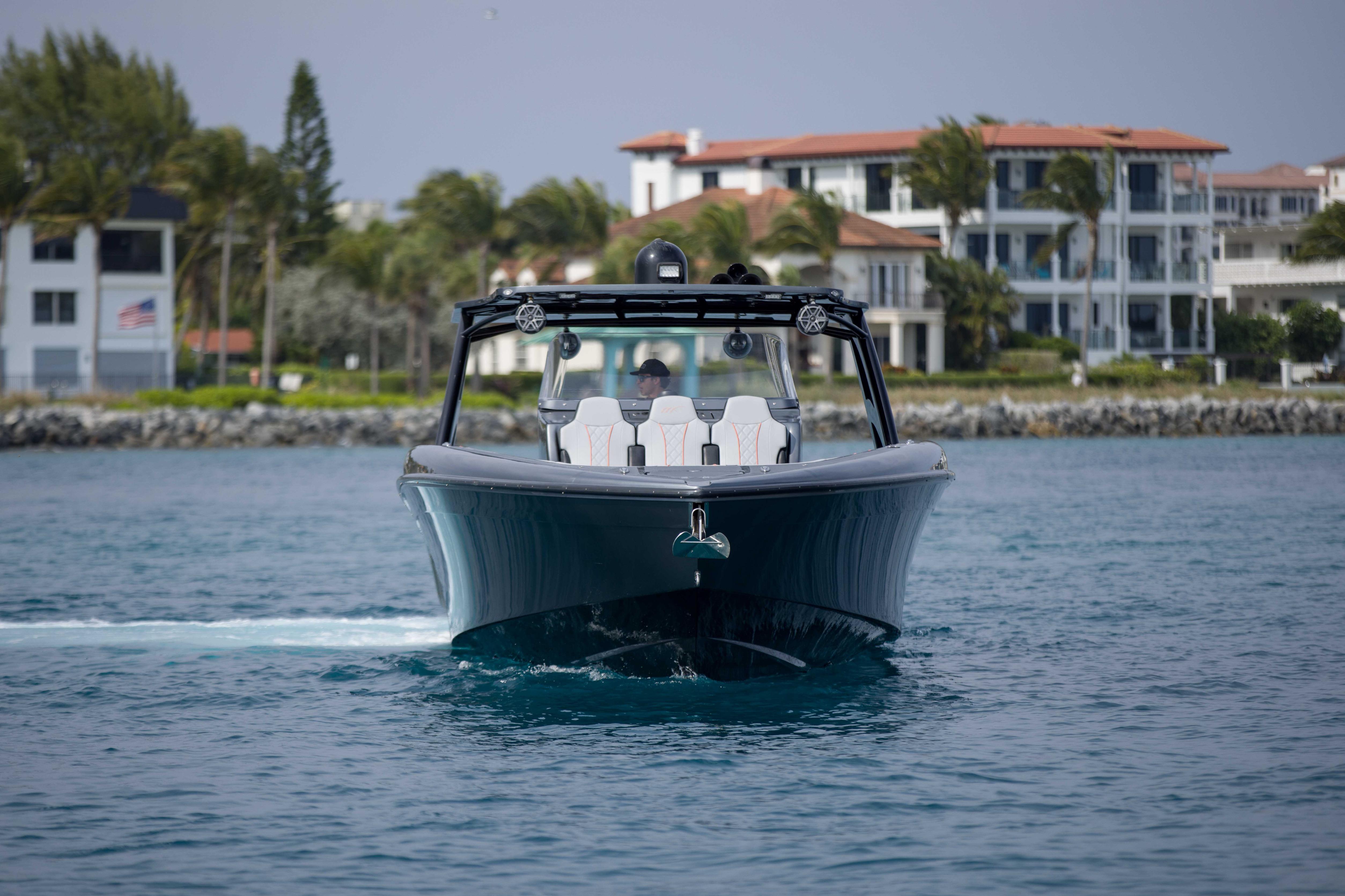 2019 Midnight Express 43 Open boat cruising near luxury waterfront homes.