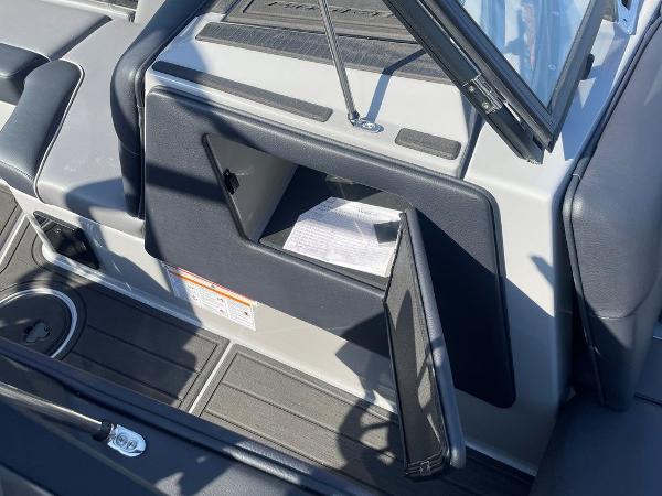 2025 Moomba Mondo boat interior with open glove compartment and visible document.