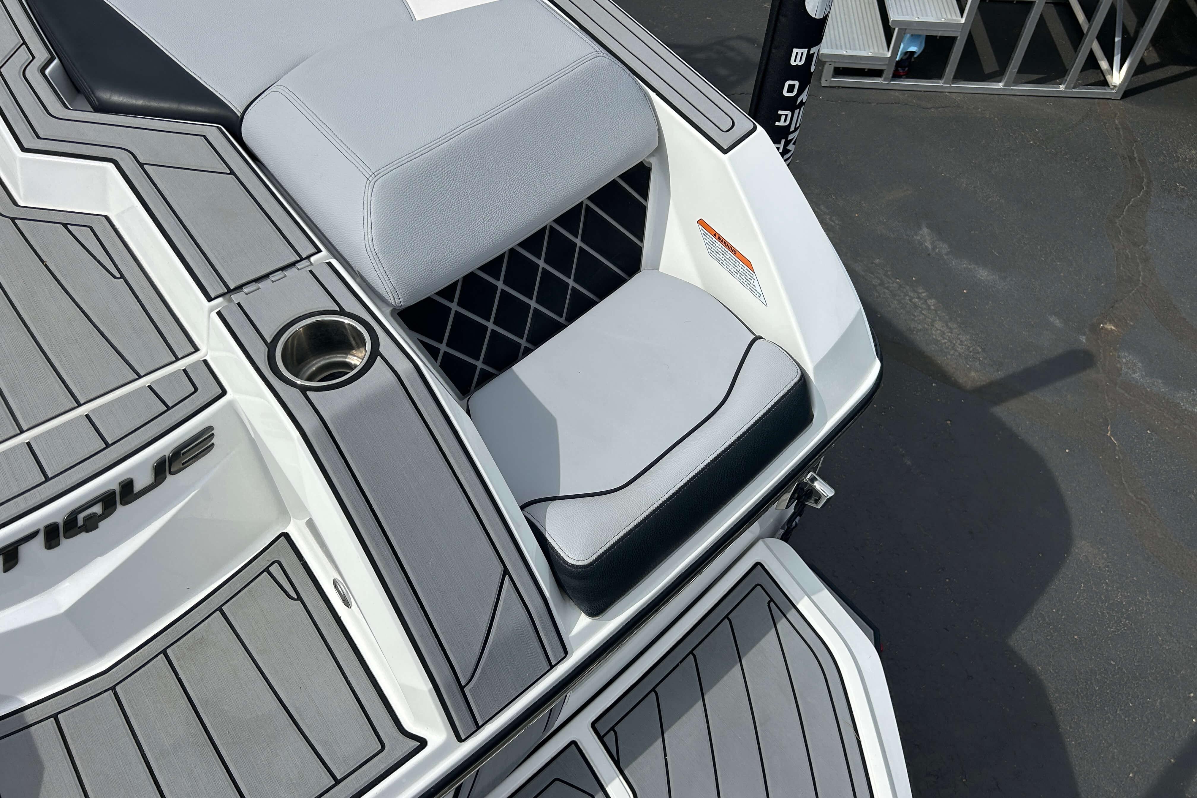 2021 Nautique Super Air Nautique GS24 boat interior with gray seating and cup holder.