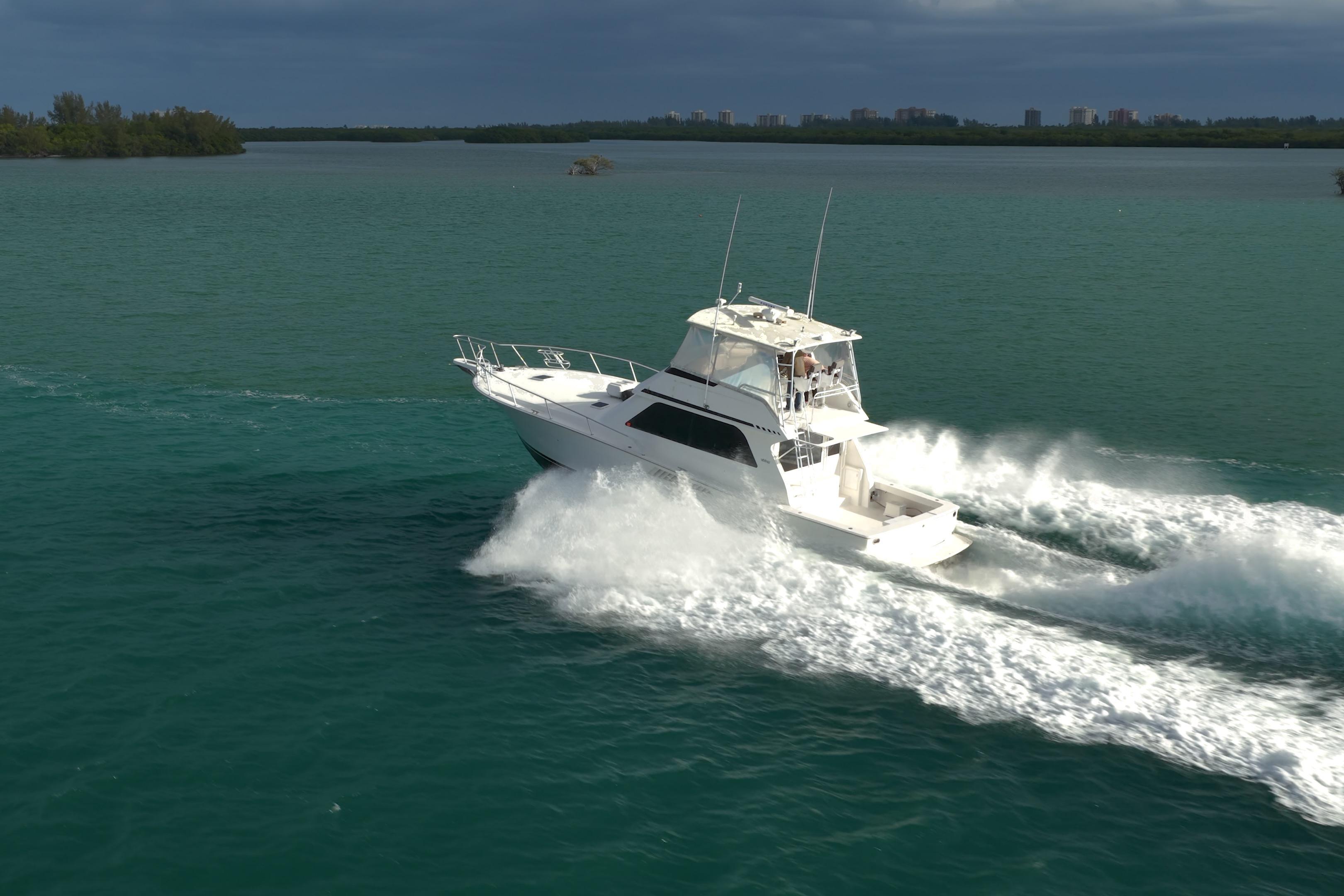 1996 Viking 50 Sport Fisher Convertible cruising on open water, creating a dynamic wake.