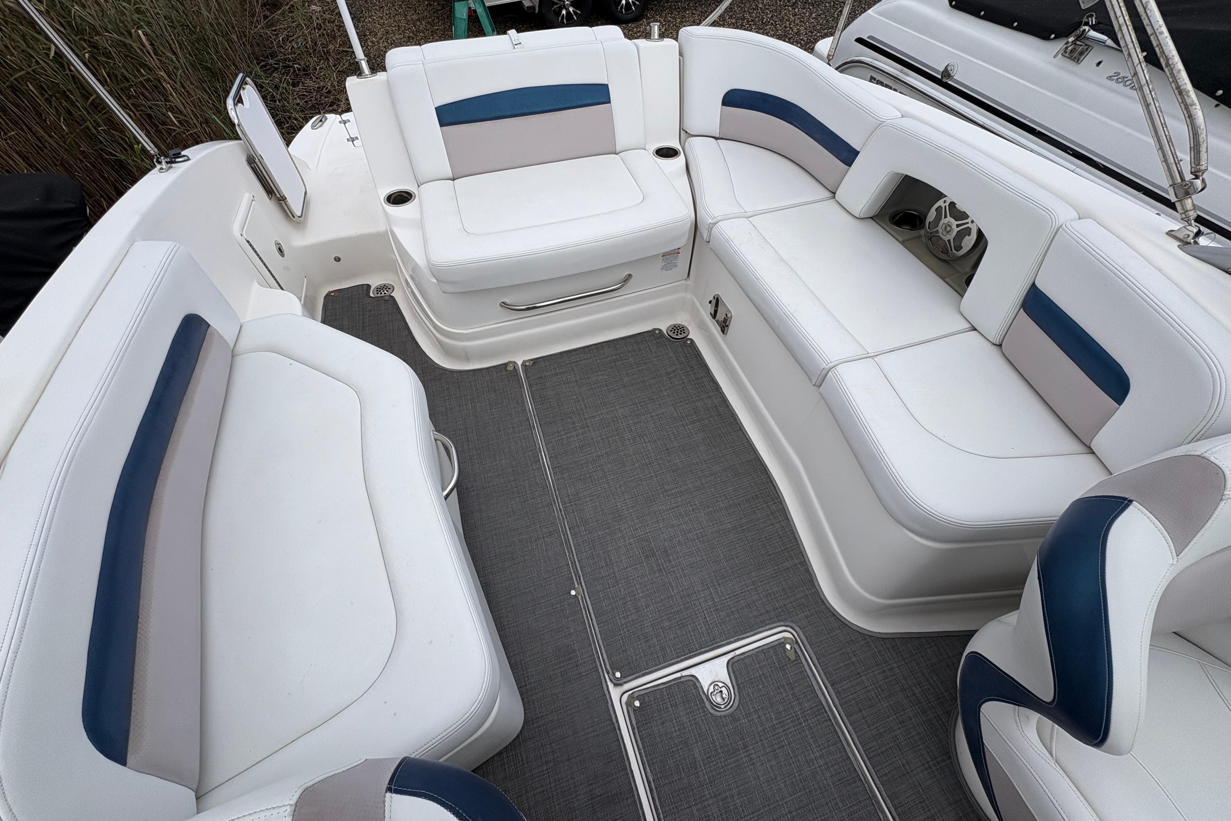 2015 Chaparral 264 Sunesta boat interior with white and blue seating arrangement.