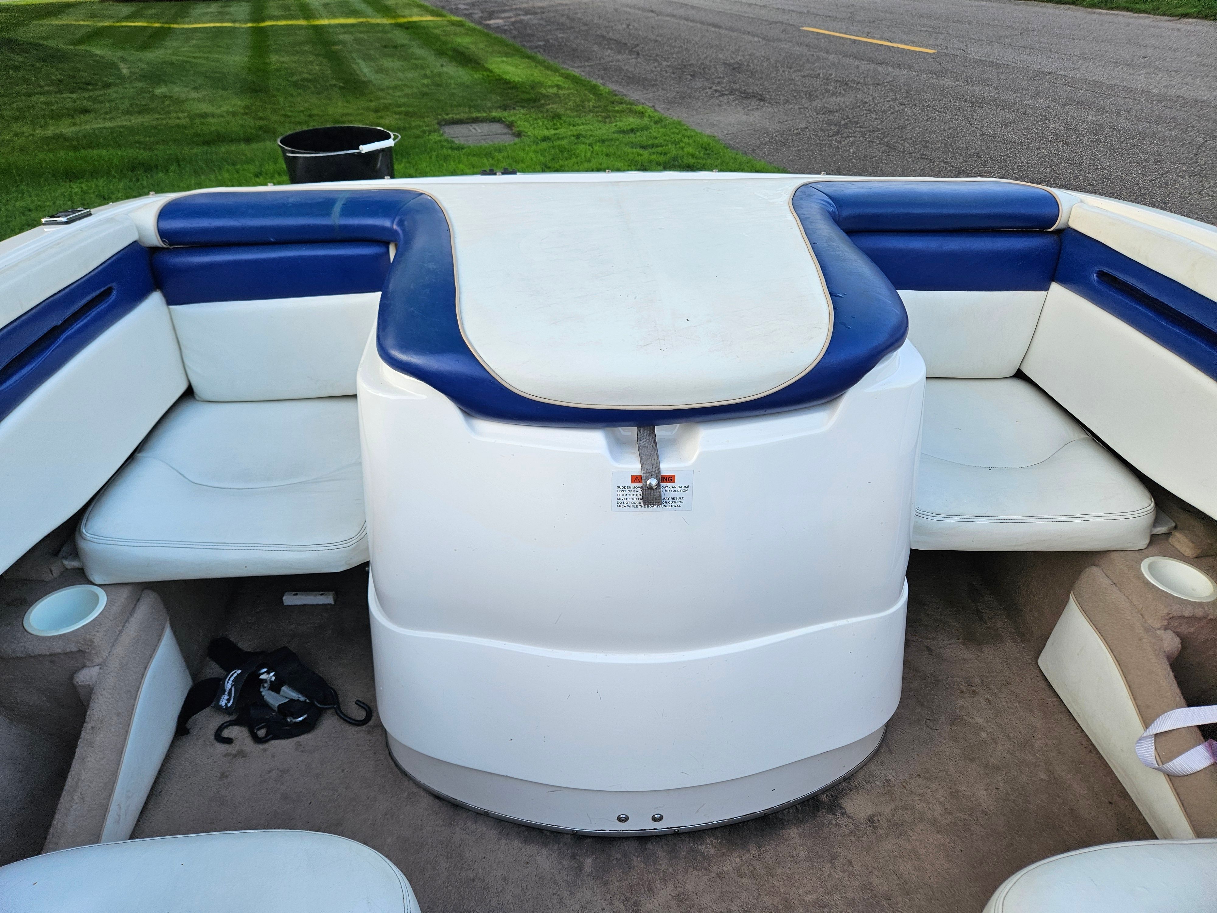 The image shows the cockpit of a 1996 Wellcraft Excel boat with blue and white seating.