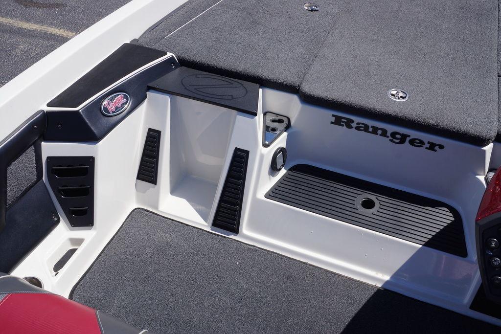 2018 Ranger Z519 boat interior with carpeted deck and storage compartments.