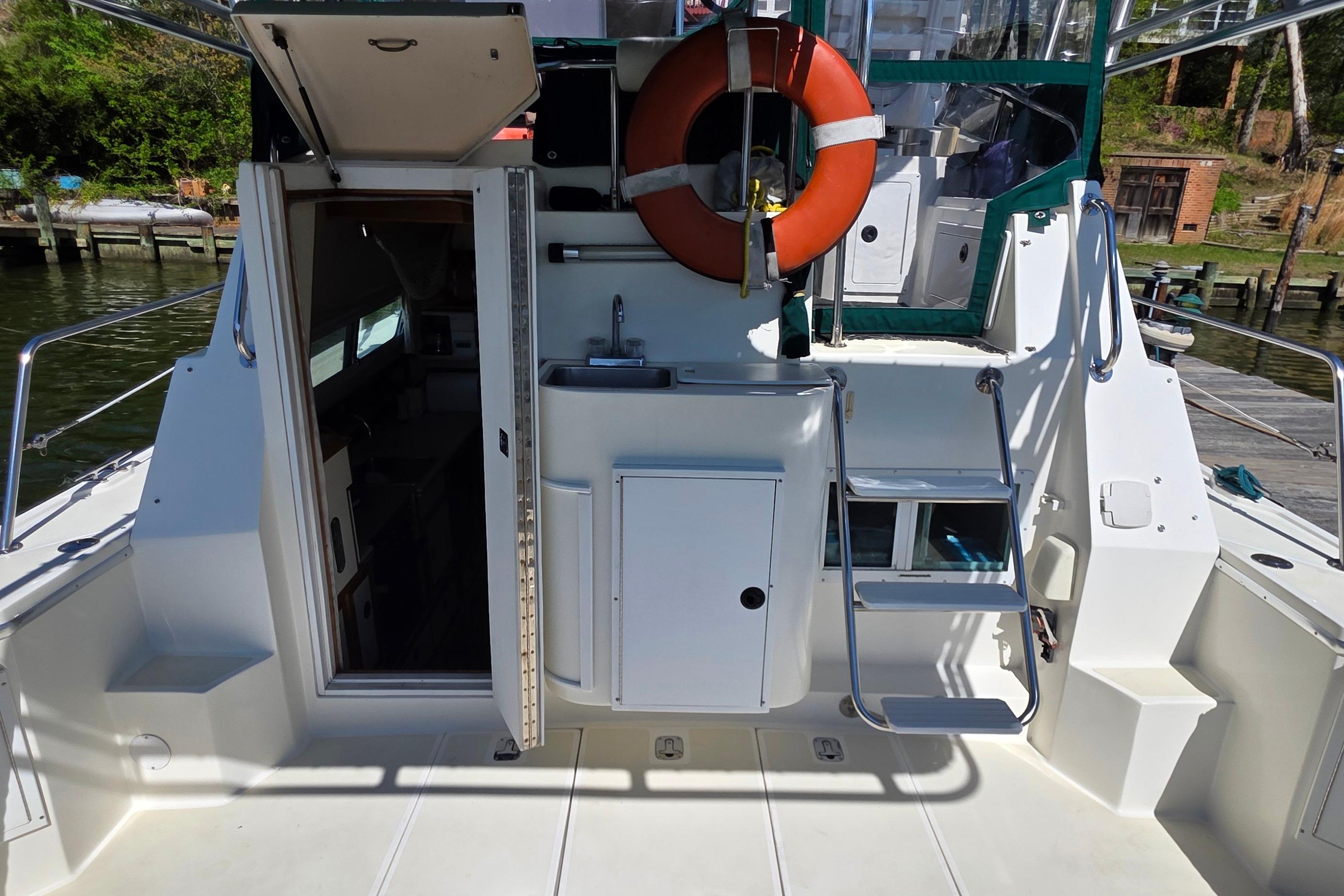 2001 Albin 32 + 2 Command Bridge boat interior with open cabin door and life preserver.