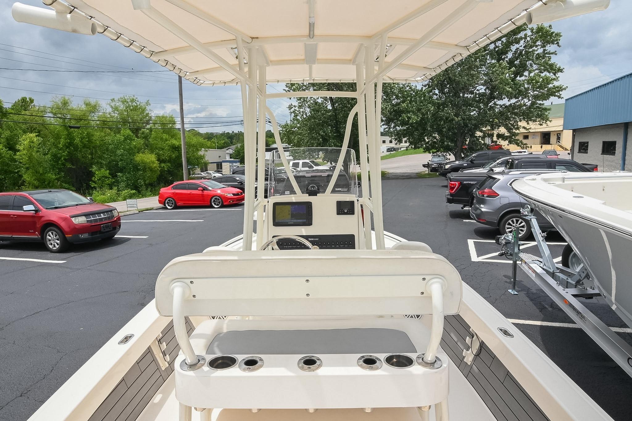 2021 Pathfinder 2200 TRS boat in parking lot, surrounded by cars and trees.