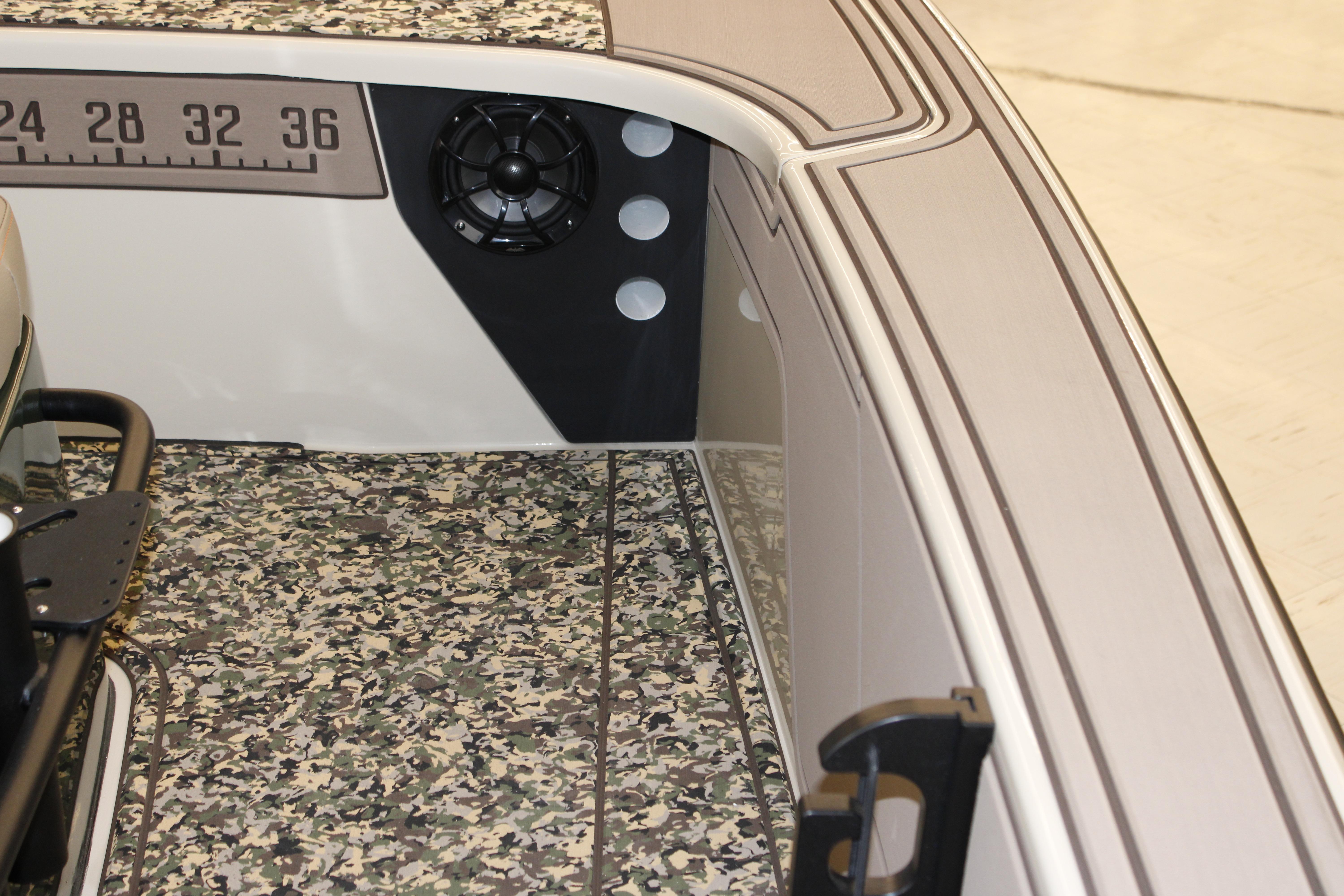 2026 Mako 18 Pro Skiff Backwater Edition interior with camo flooring and speaker detail.