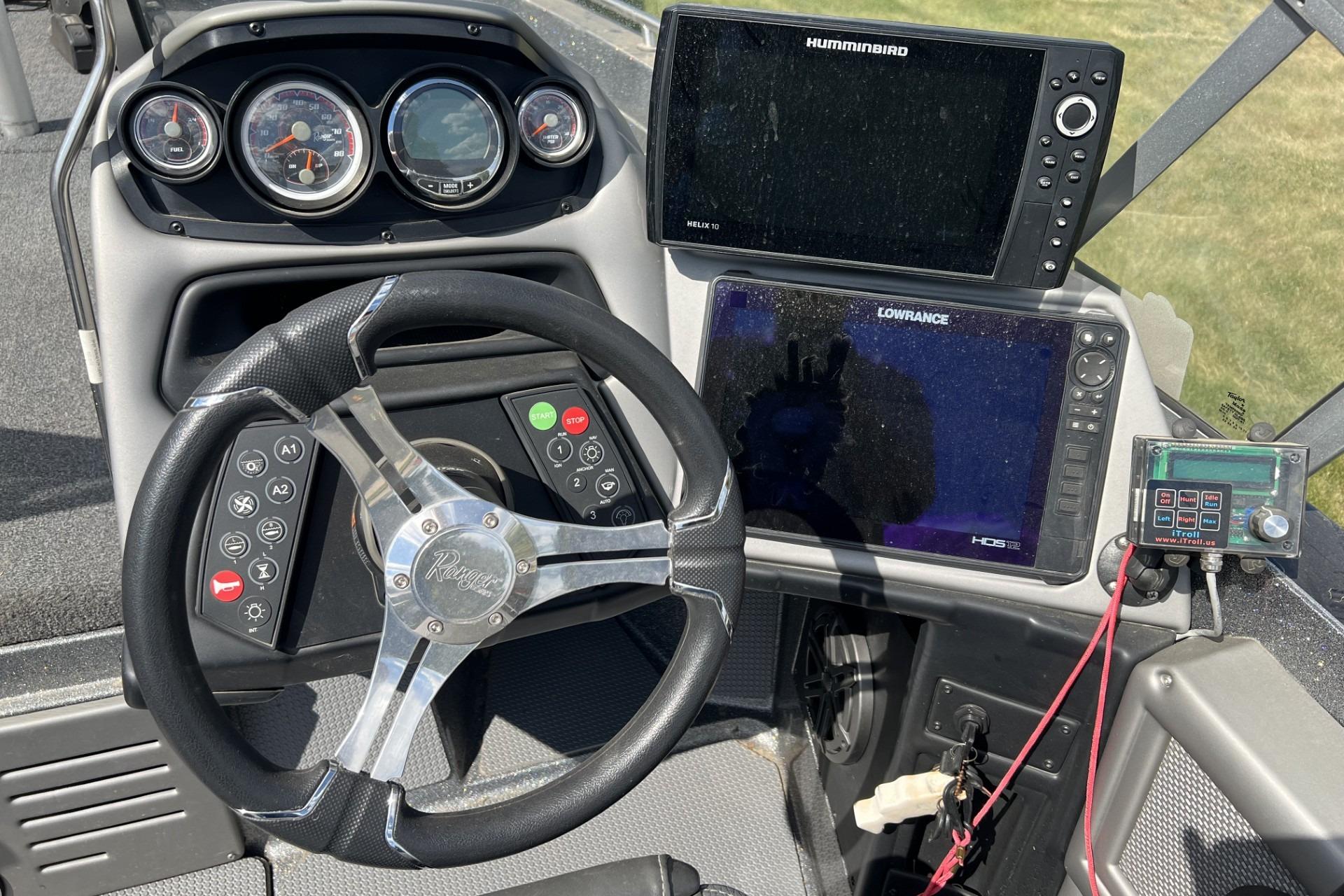 2023 Ranger 620FS Cup-Equipped boat dashboard with steering wheel and navigation displays.