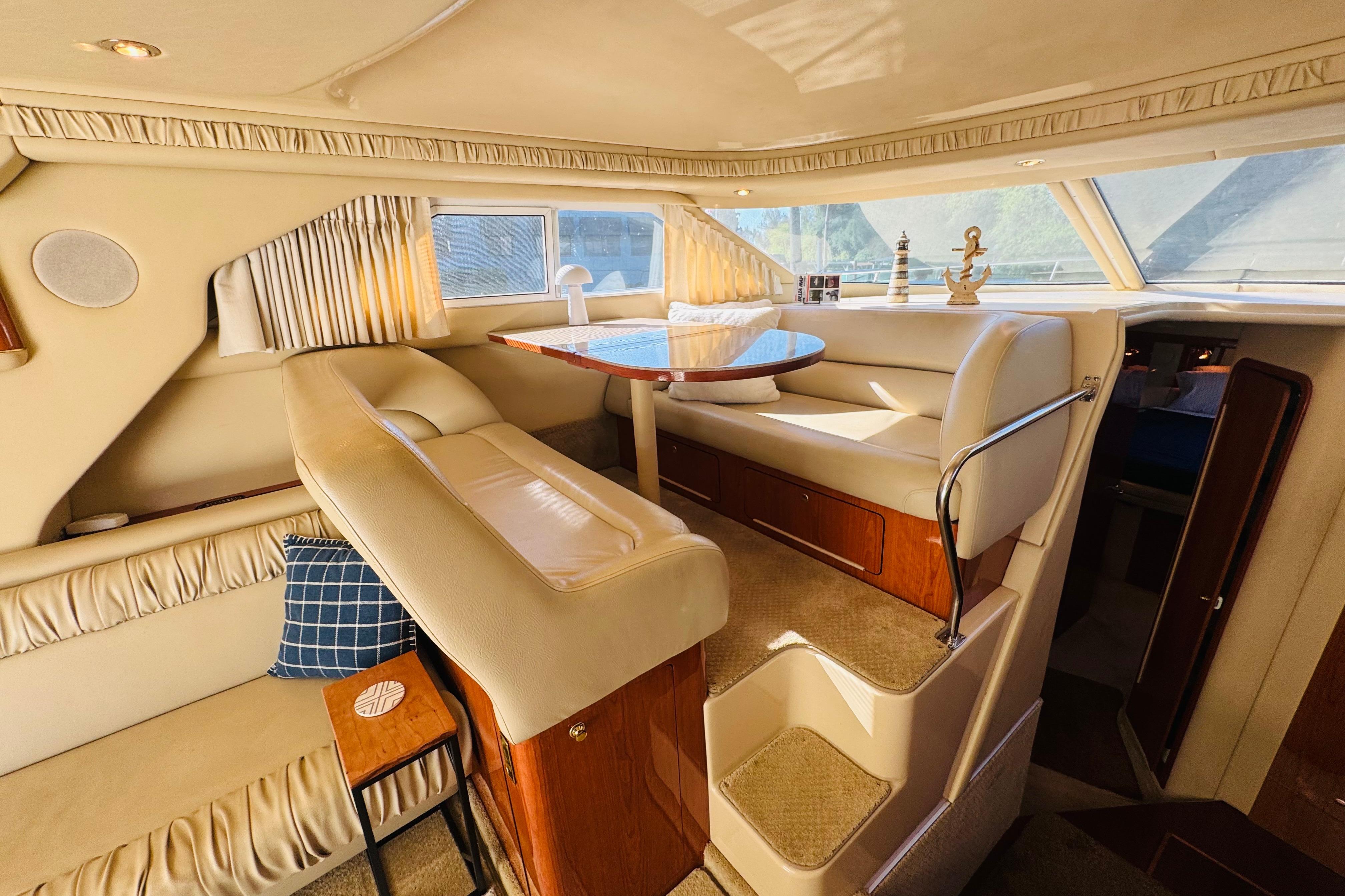 Luxurious interior of 2000 Sea Ray 400 Sedan Bridge yacht with elegant seating and decor.