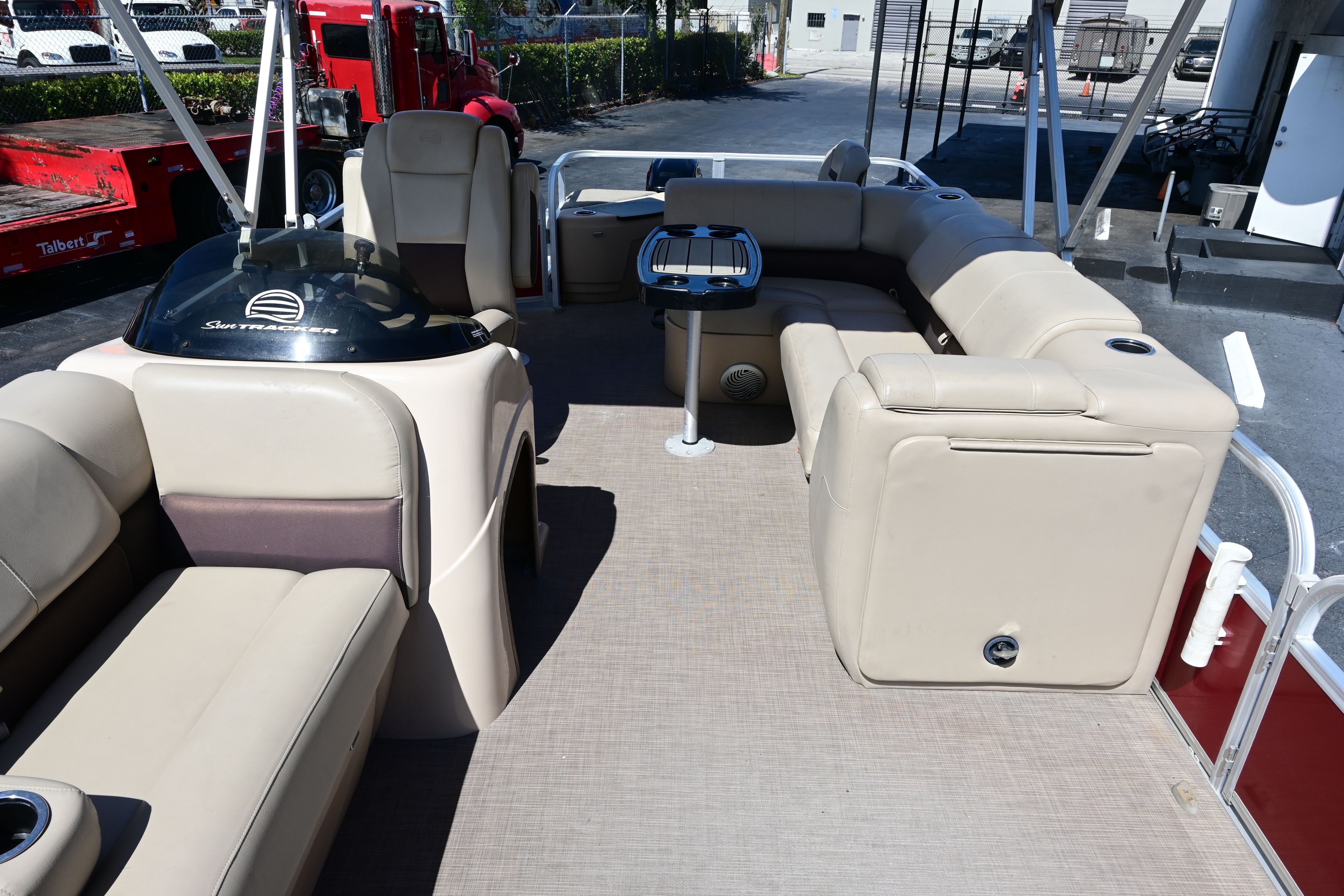Interior of a 2019 Sun Tracker FISHI pontoon boat with beige seating.