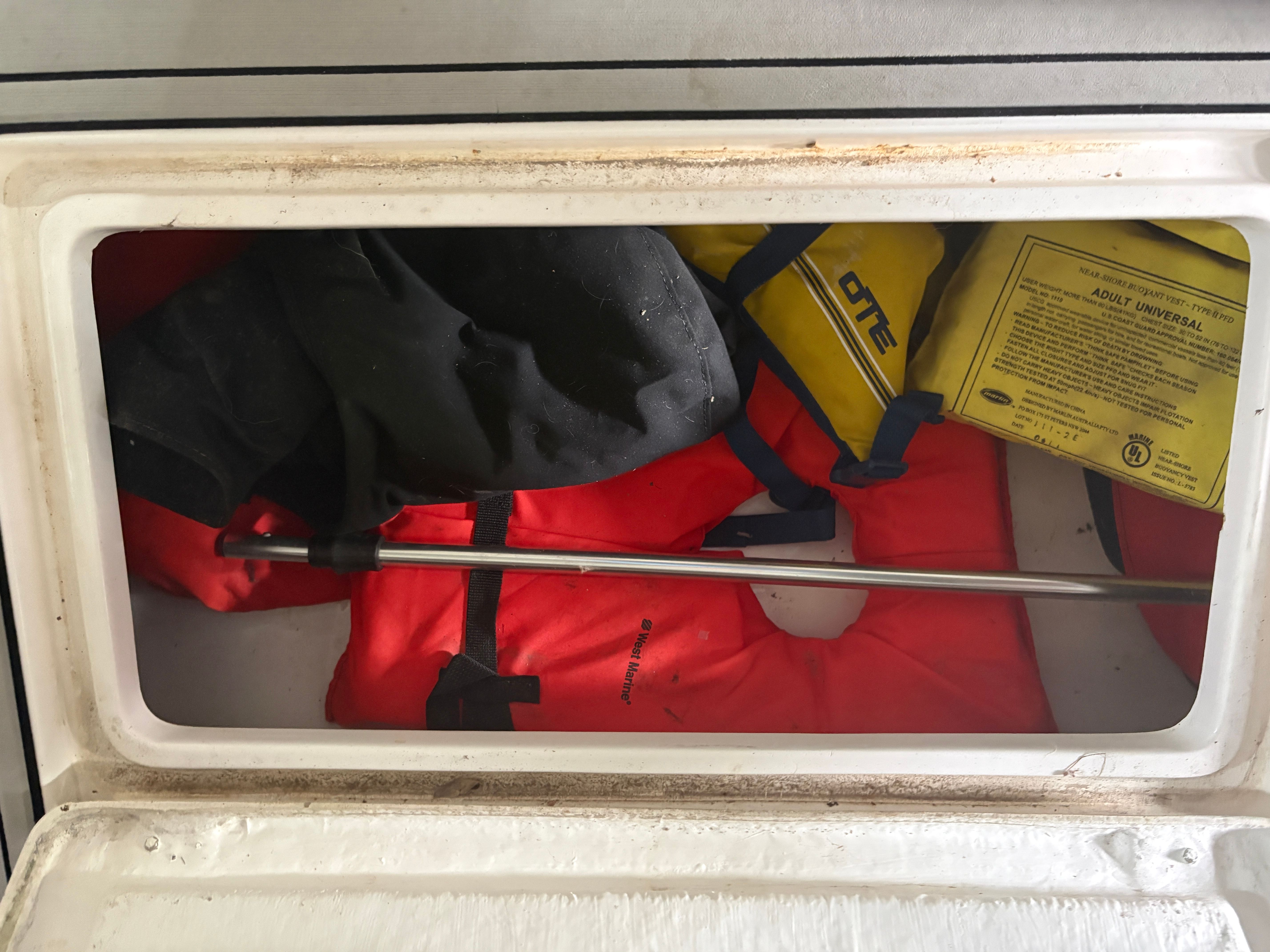 Life jackets in storage compartment of Intrepid 322 Cuddy Center Console boat.