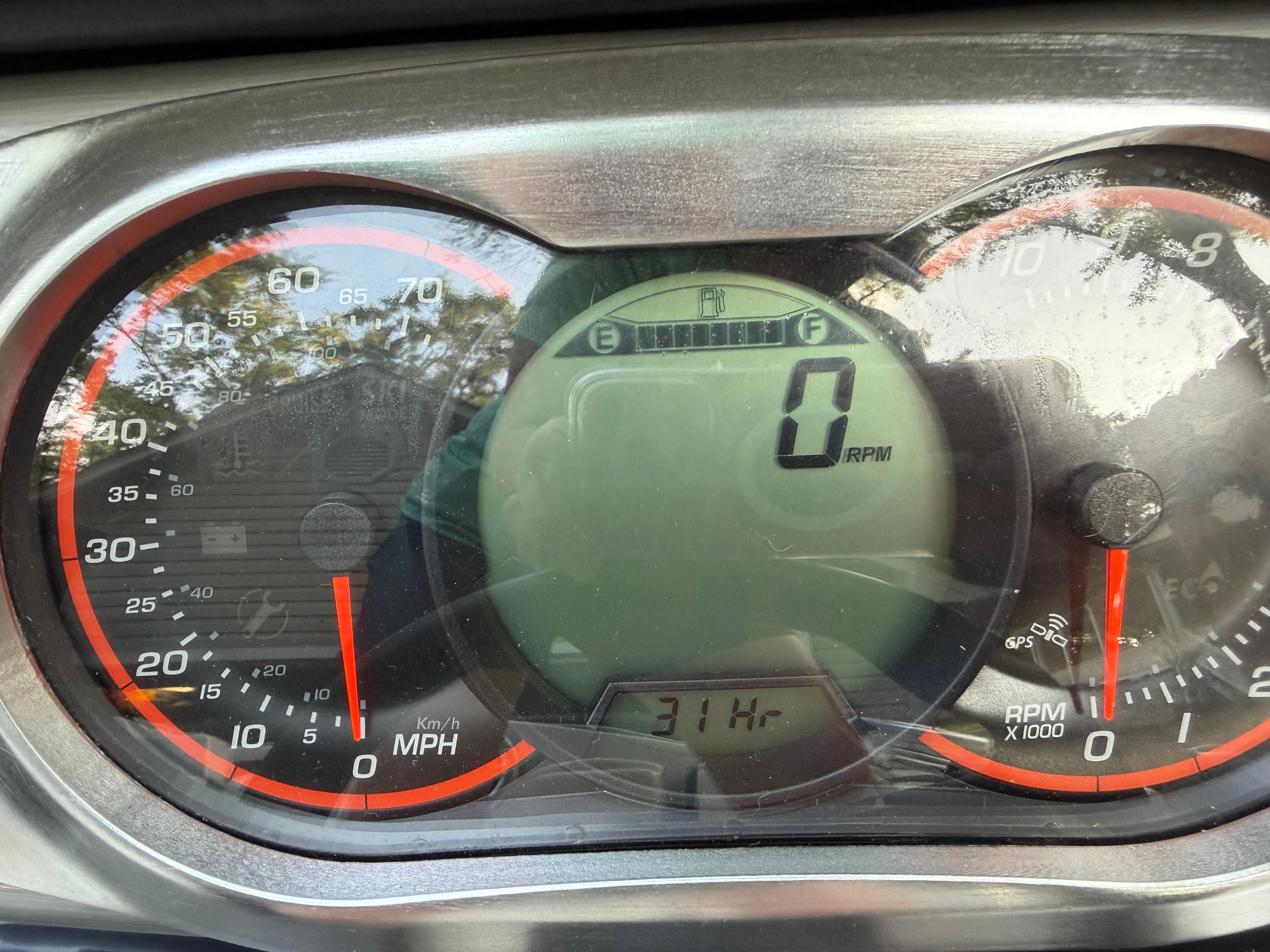 Close-up of a speedometer and tachometer with a digital display.