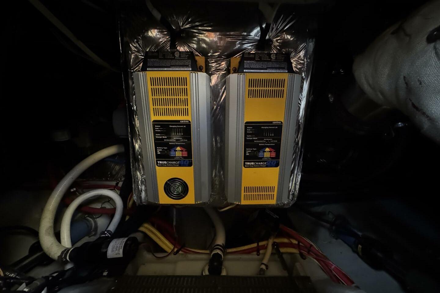Engine room of 2008 Meridian 459 Motoryacht with battery chargers and wiring.