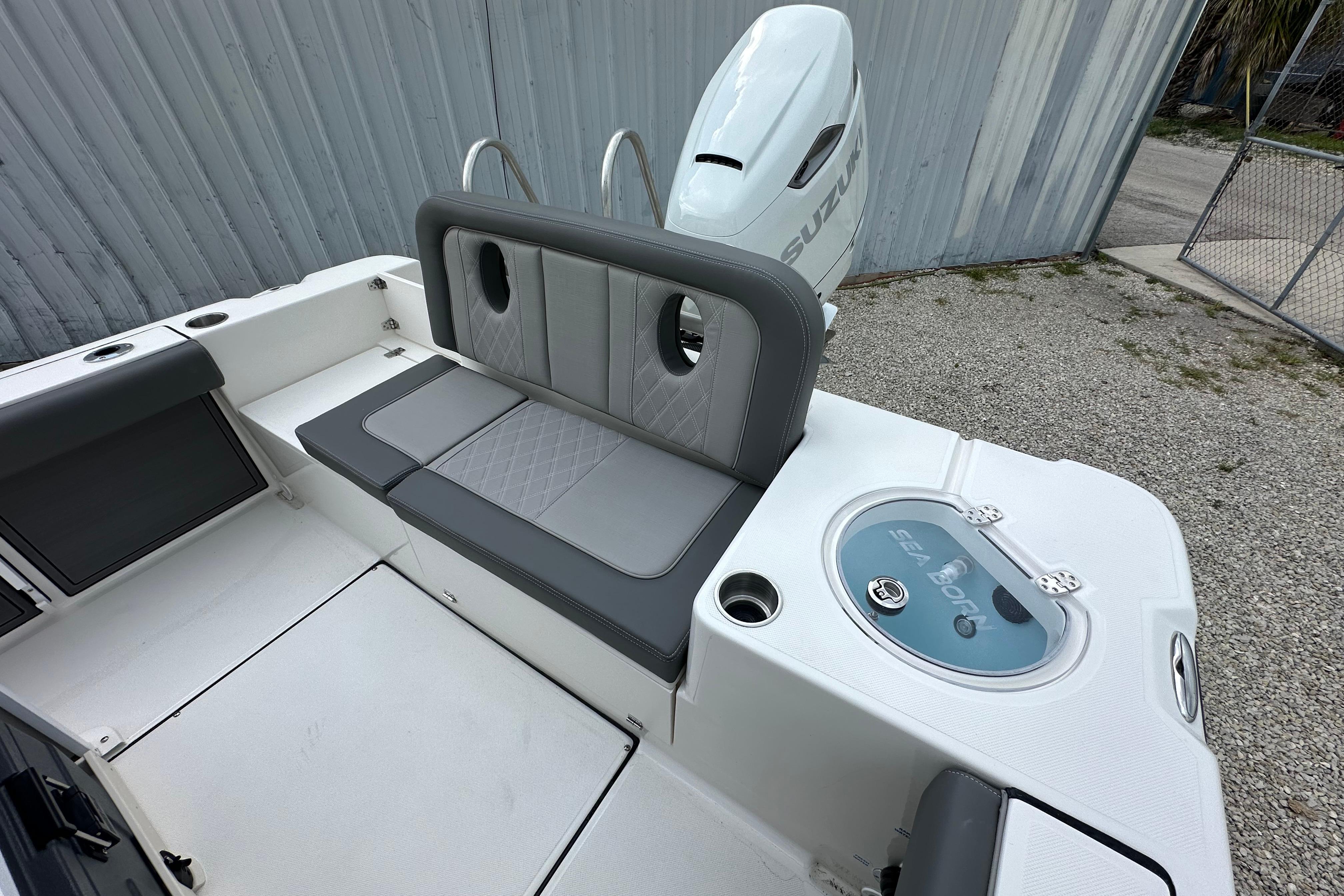 2027 Sea Born LX24 Center Console boat interior with seating and Suzuki engine.