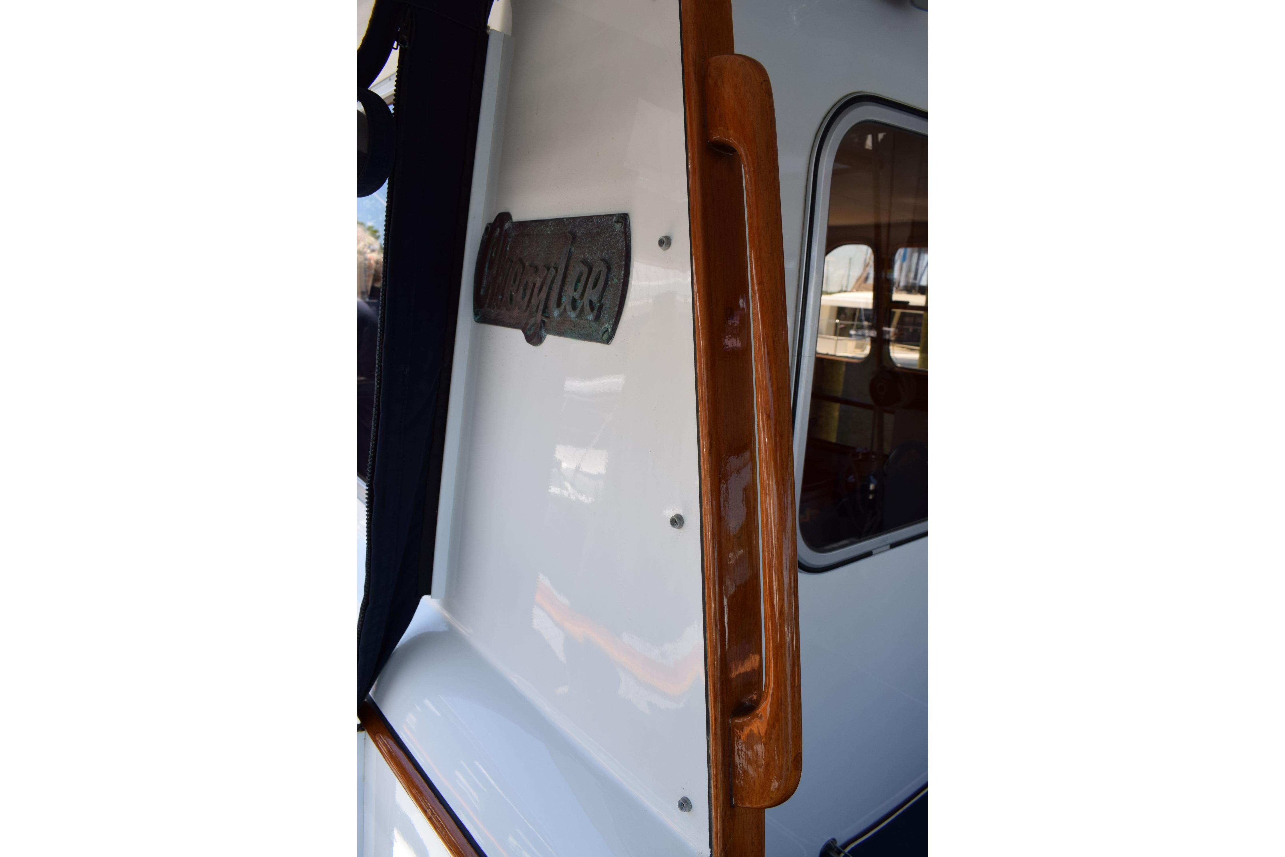1980 Cheoy Lee 52 Motorsailer with polished wood handle and nameplate.