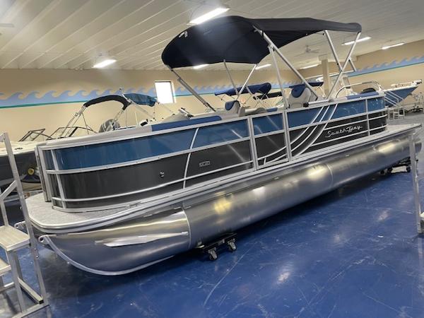 2025 South Bay LE pontoon boat with canopy in showroom.