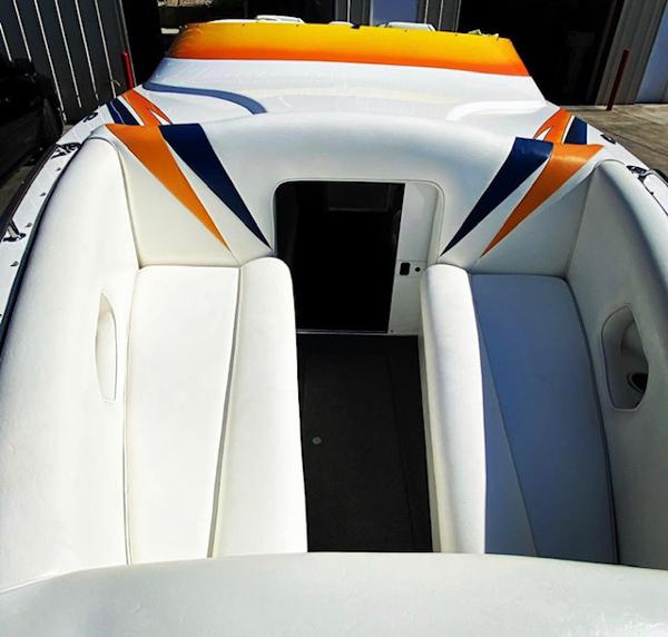 2001 Eliminator Eagle boat interior with white seats and colorful accents.