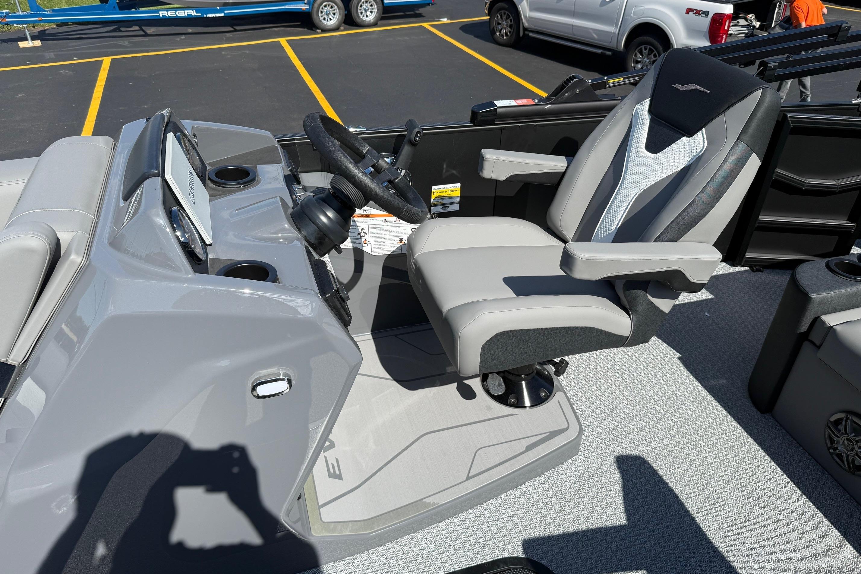 Captain's chair and helm of 2026 Evotti 521CS boat, featuring modern design and controls.