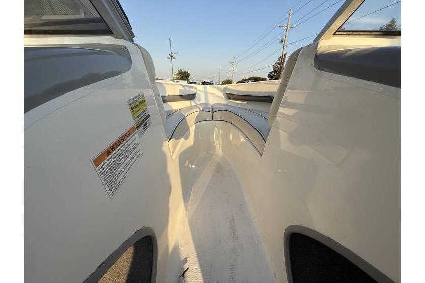 2008 Bayliner 185 Bowrider interior view with seating and warning label.