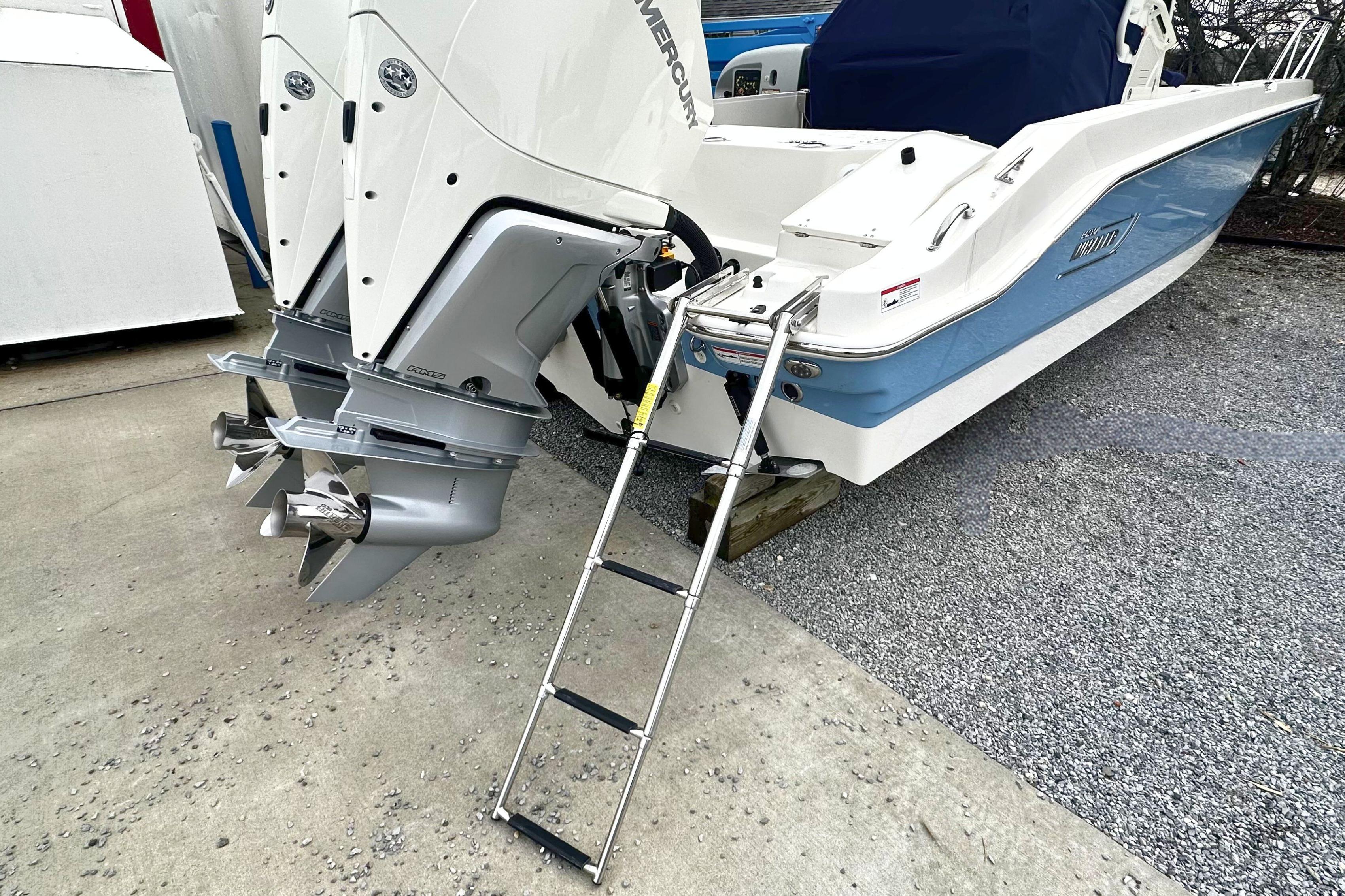 2026 Boston Whaler 280 Dauntless boat with dual outboard engines and boarding ladder.
