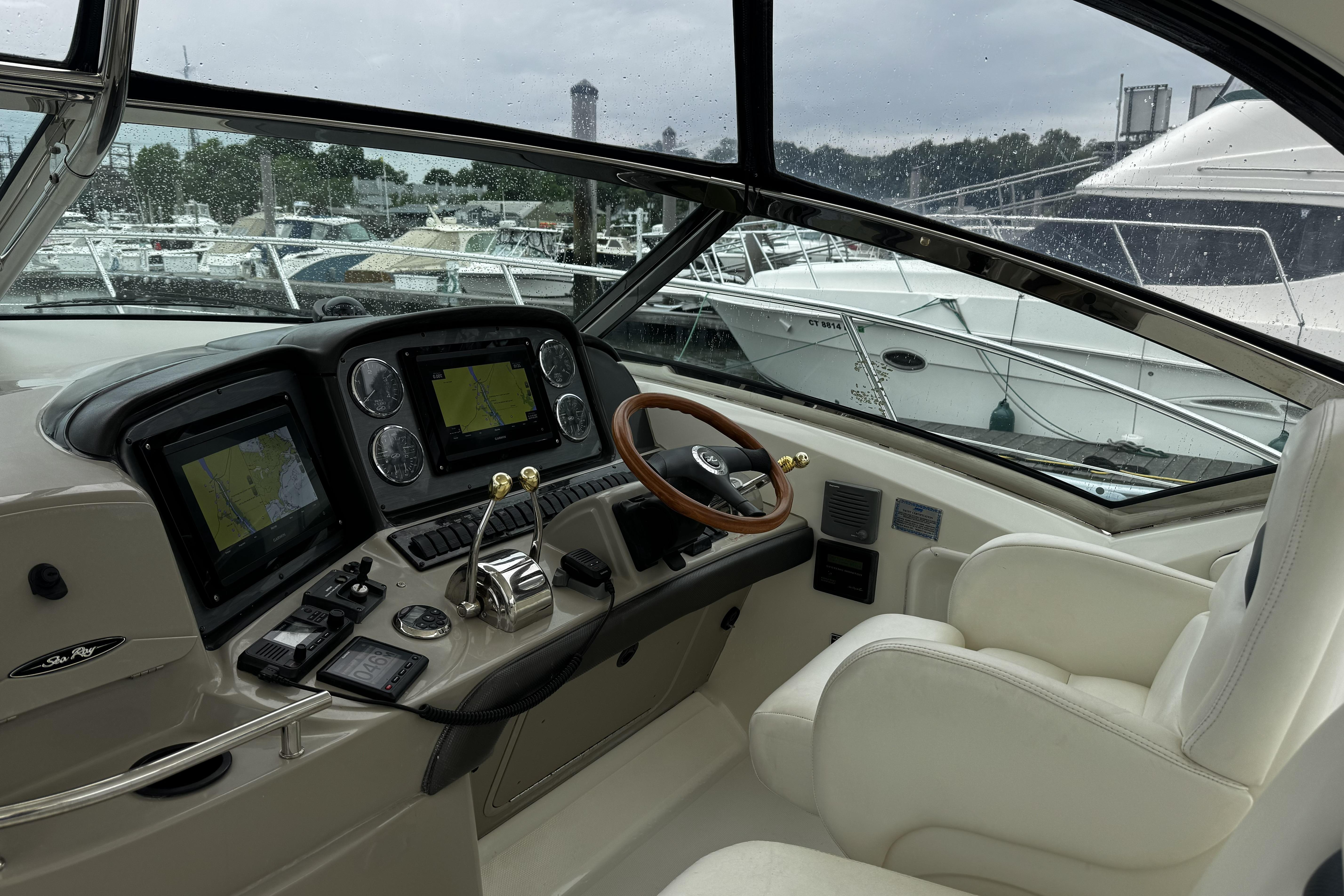 Helm of 2006 Sea Ray 40 Sundancer with navigation screens and controls.