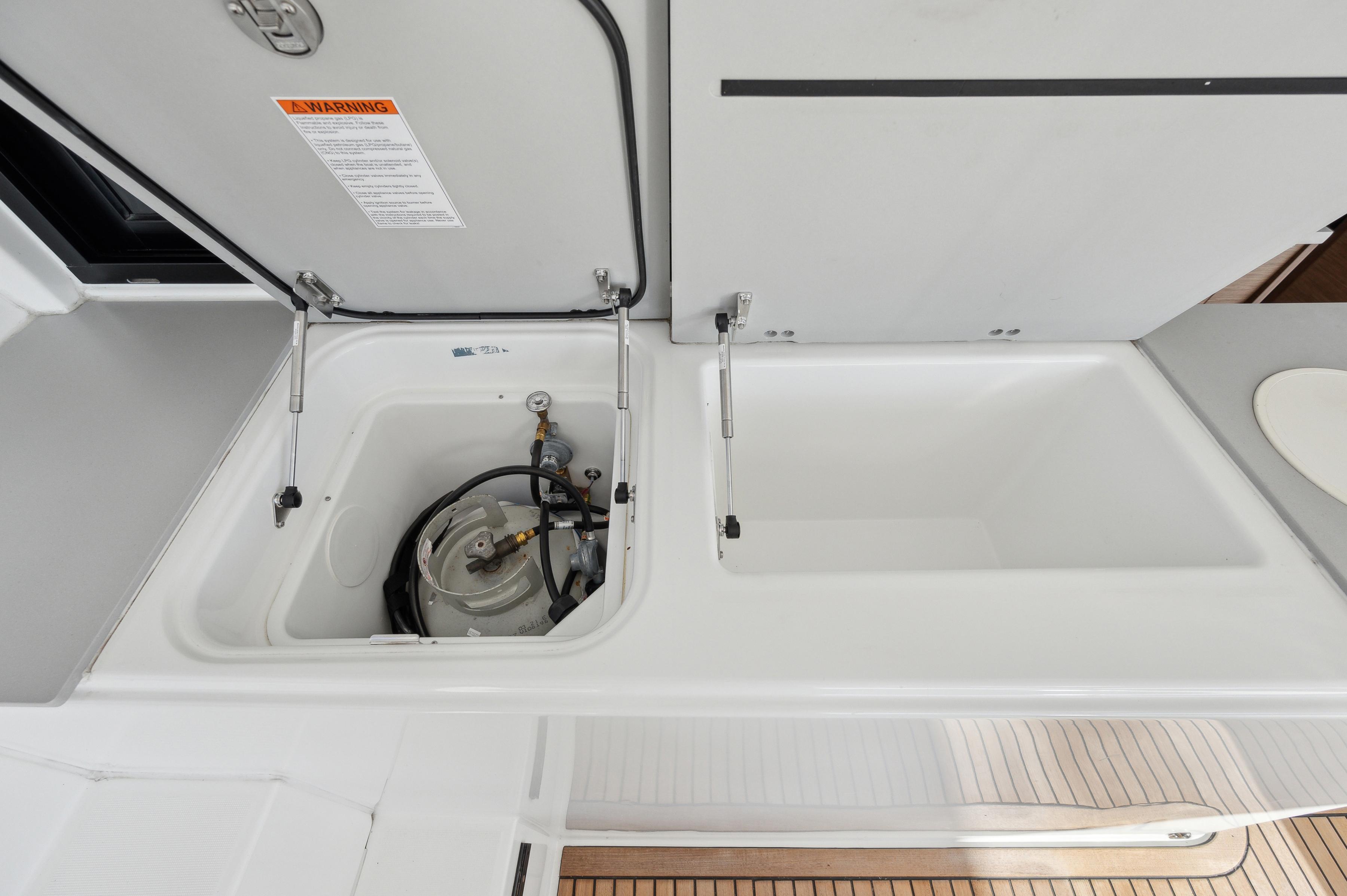 Lagoon 46 yacht 2022 model with open storage compartment and equipment.