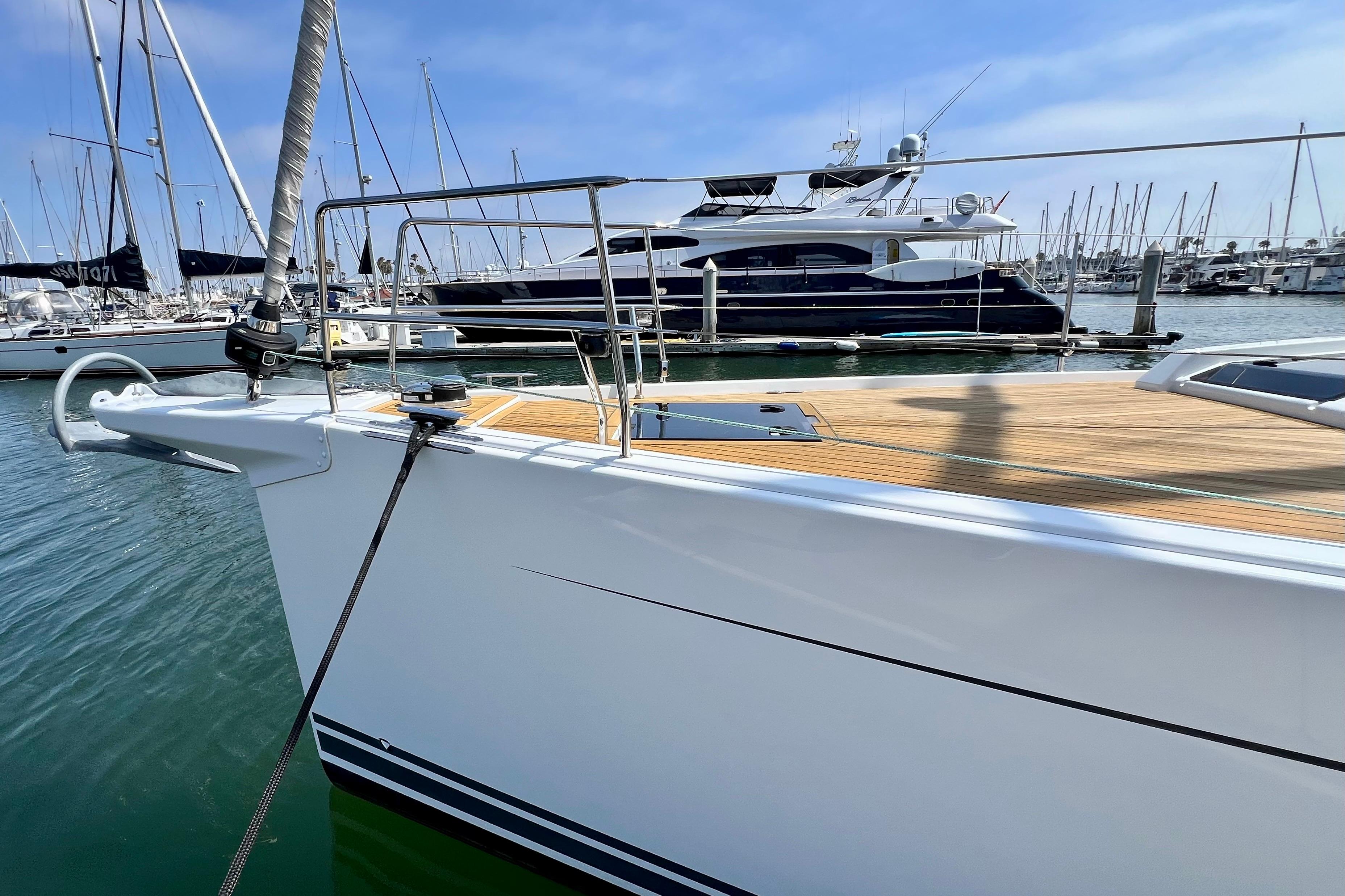 2016 Hanse 455 yacht docked in marina, showcasing sleek design and wooden deck.