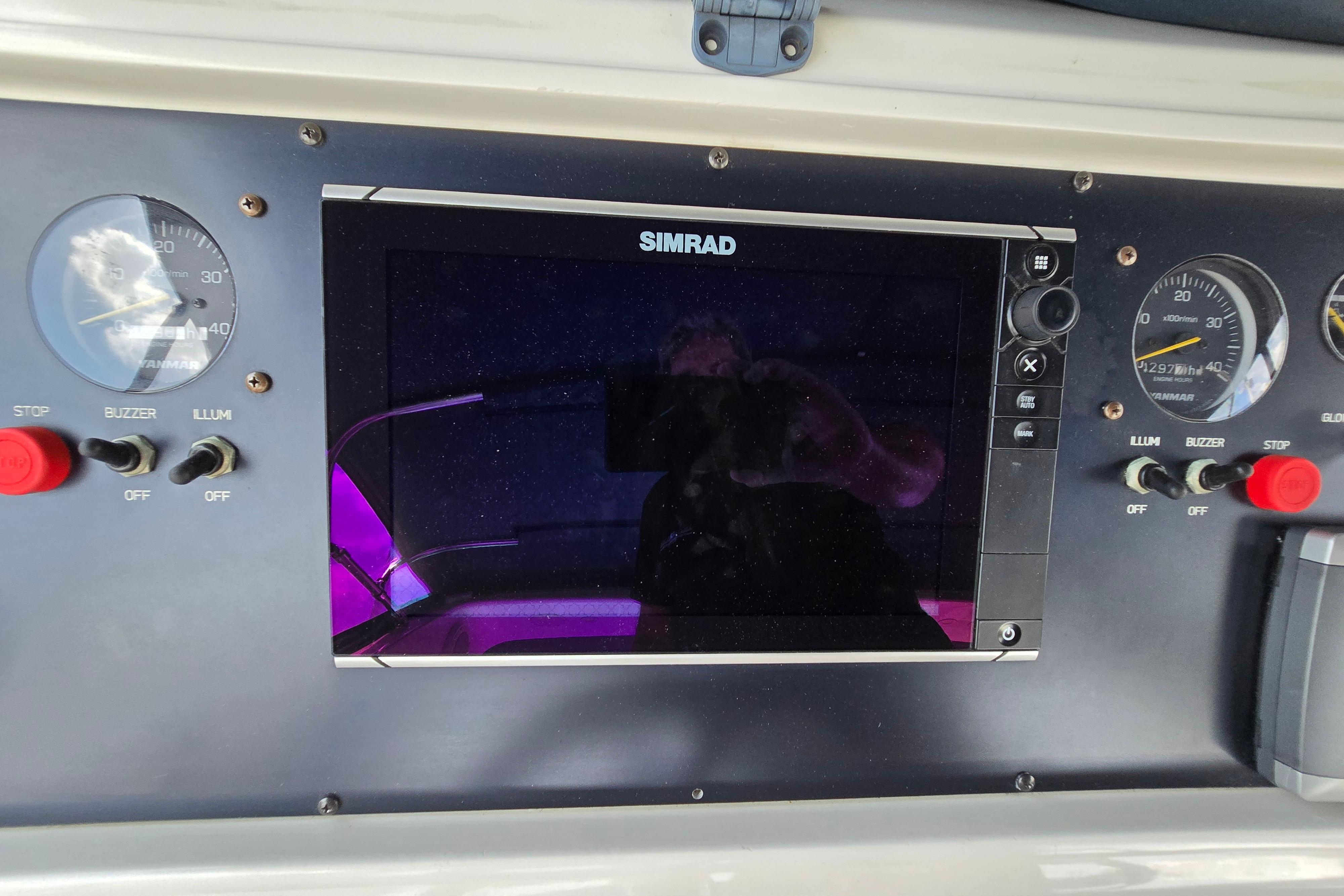 Control panel of a 2004 Grand Harbour 58 yacht with Simrad display and gauges.