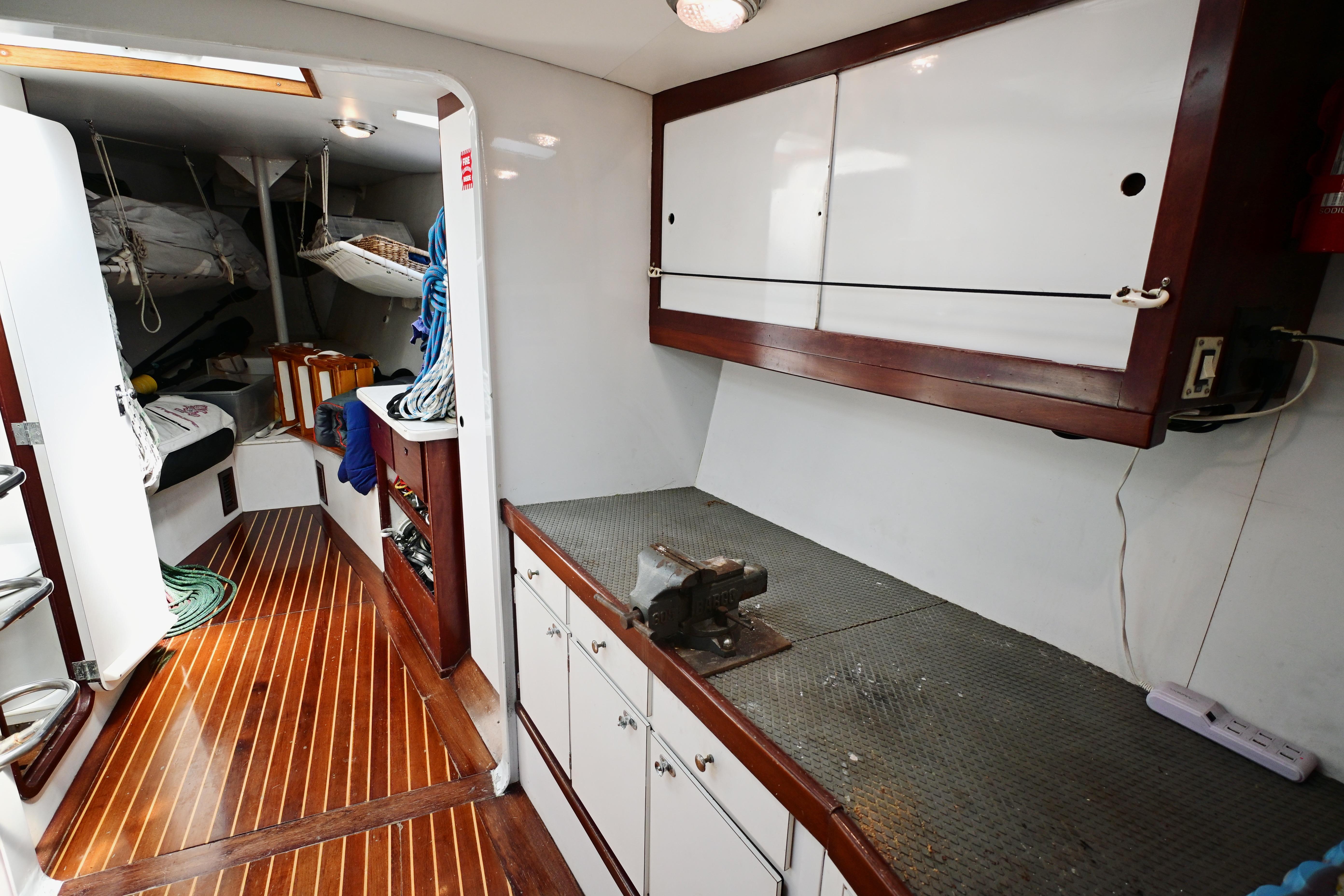 Interior of 1968 Abeking & Rasmussen Tripp 74 yacht with wooden flooring and storage cabinets.