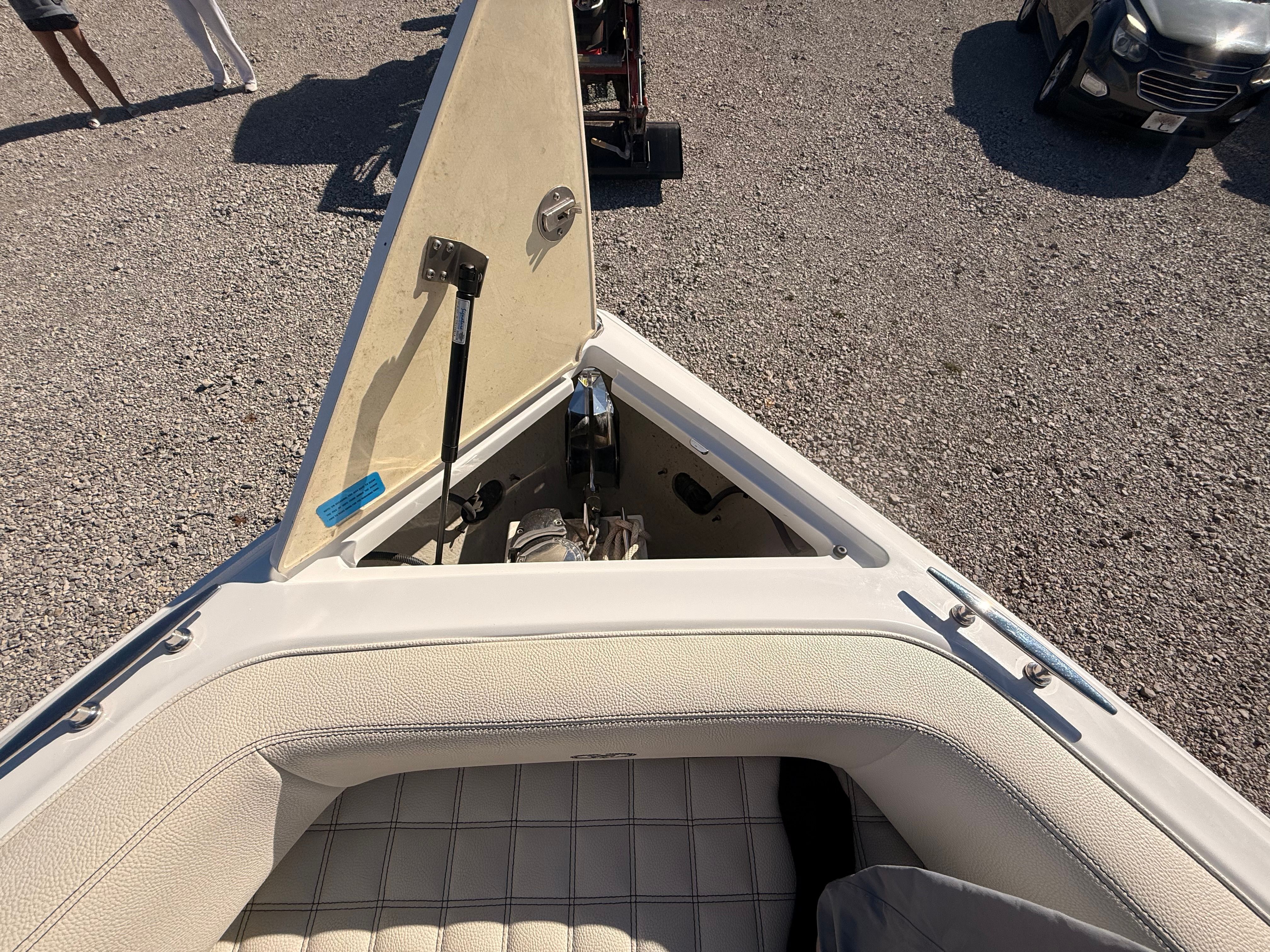 The image shows the bow of a 2019 Cobalt R7 Surf boat with an open anchor locker.