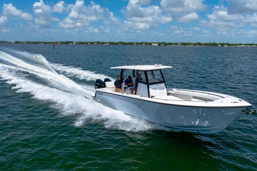 2027 Reef Runner 340 boat cruising on open water under a clear sky.