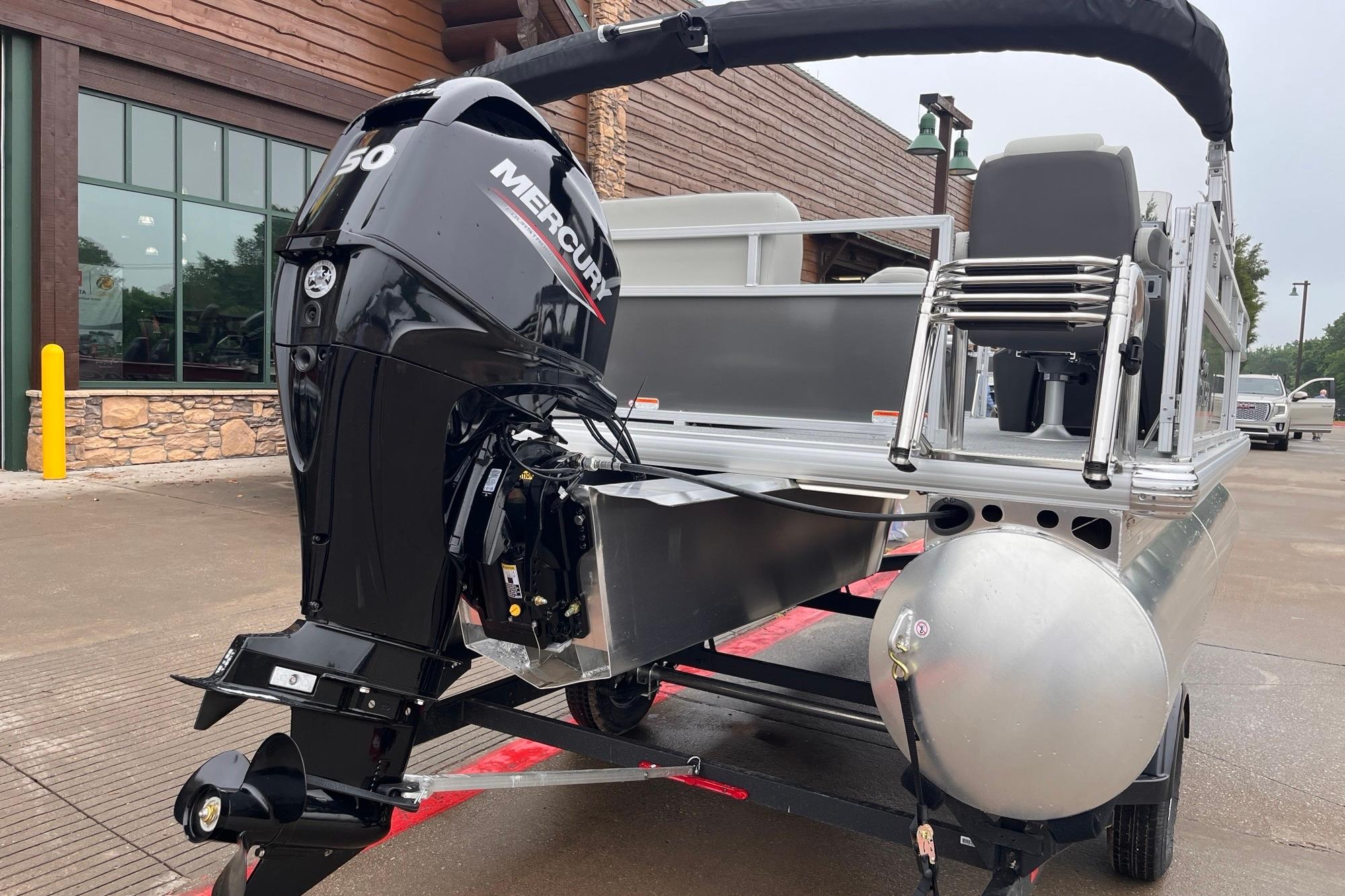 2026 Sun Tracker Bass Buggy 16 XL Select pontoon boat with Mercury outboard motor.
