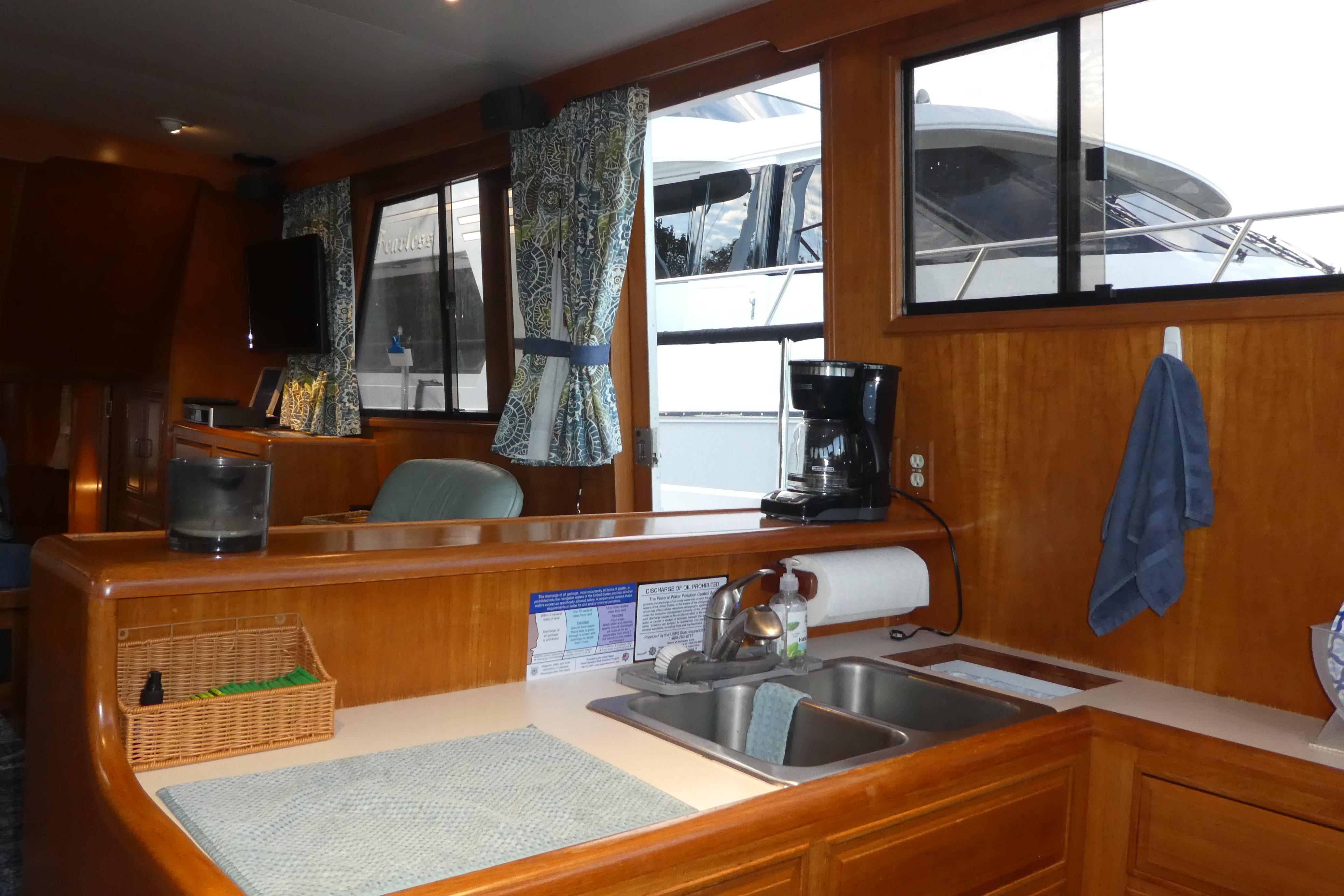 Interior of 1992 Ocean Alexander 456 Classicco yacht with kitchen and window view.