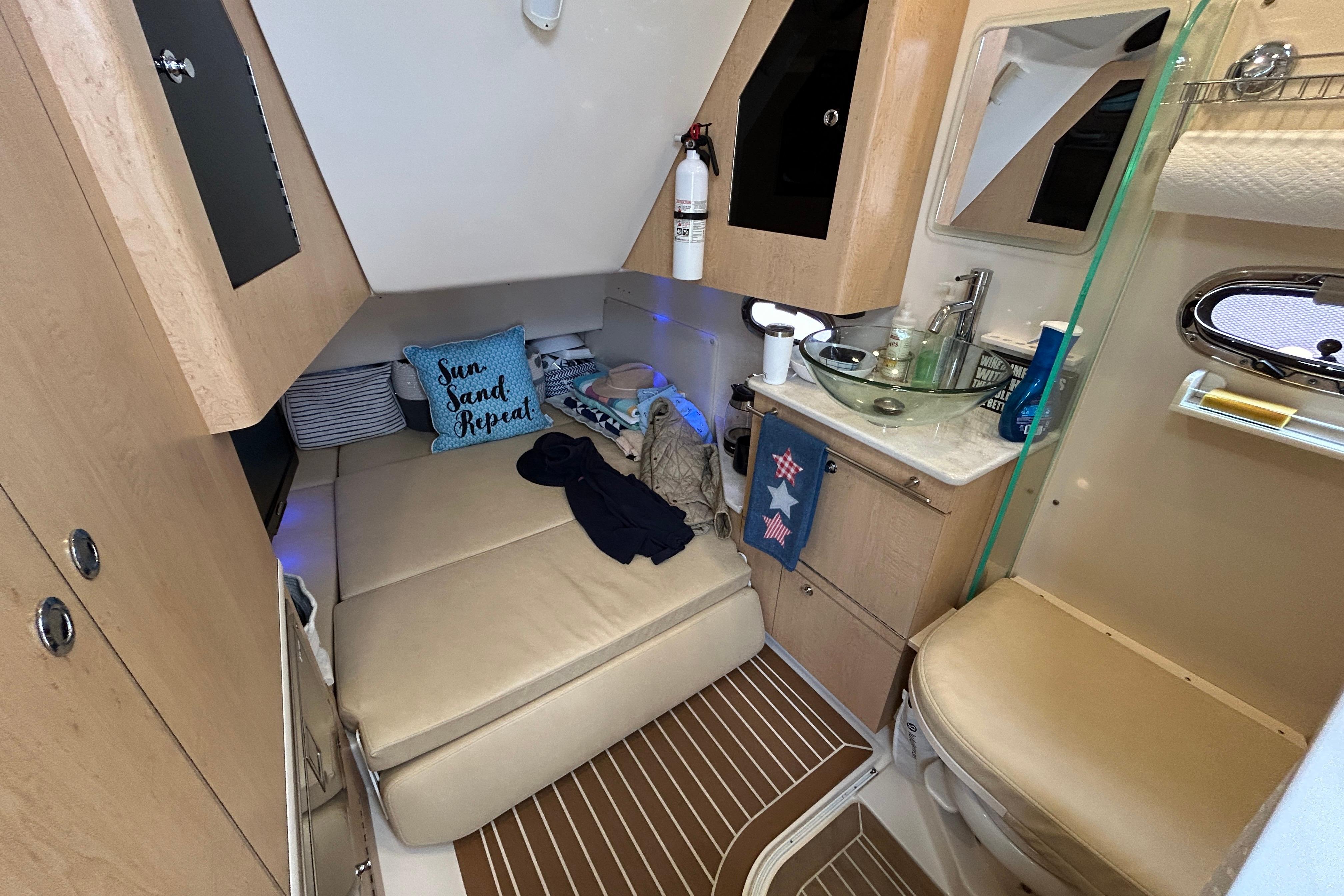 2017 Boston Whaler 370 Outrage cabin interior with bed, sink, and toilet.