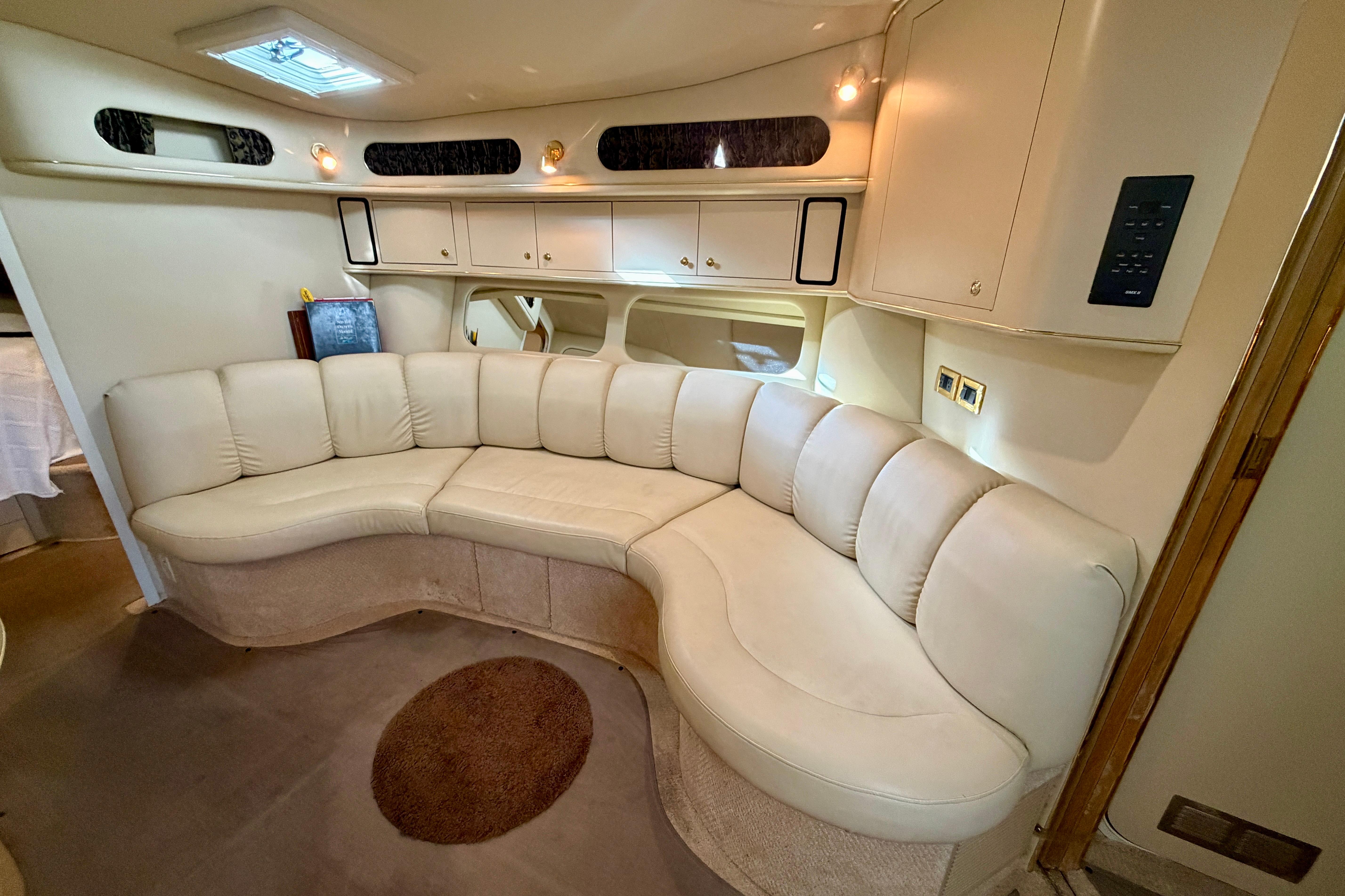 Luxurious interior of 1999 Sea Ray 400 Sundancer with curved leather seating.