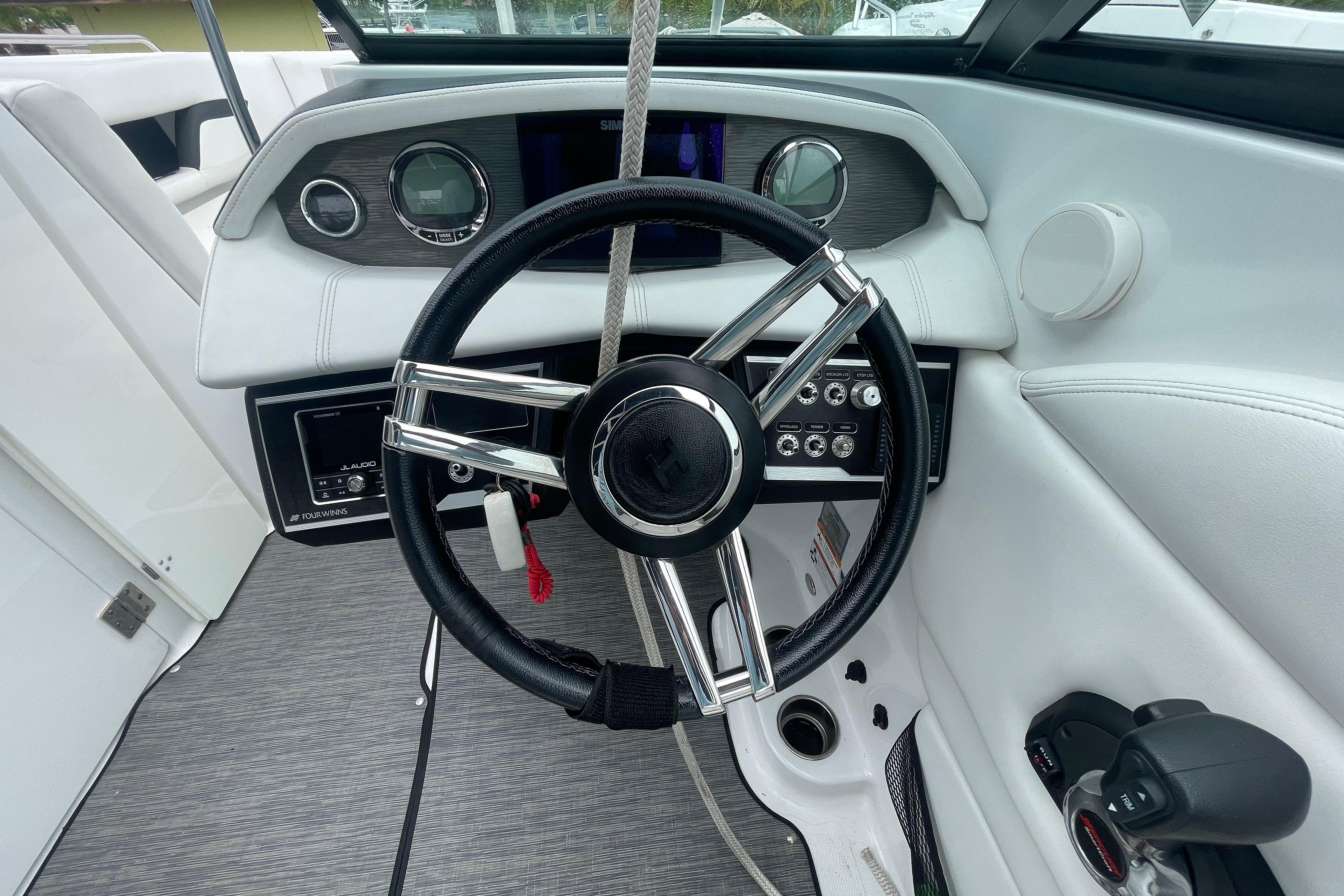 2022 Four Winns HD8 OB boat dashboard with steering wheel and controls.