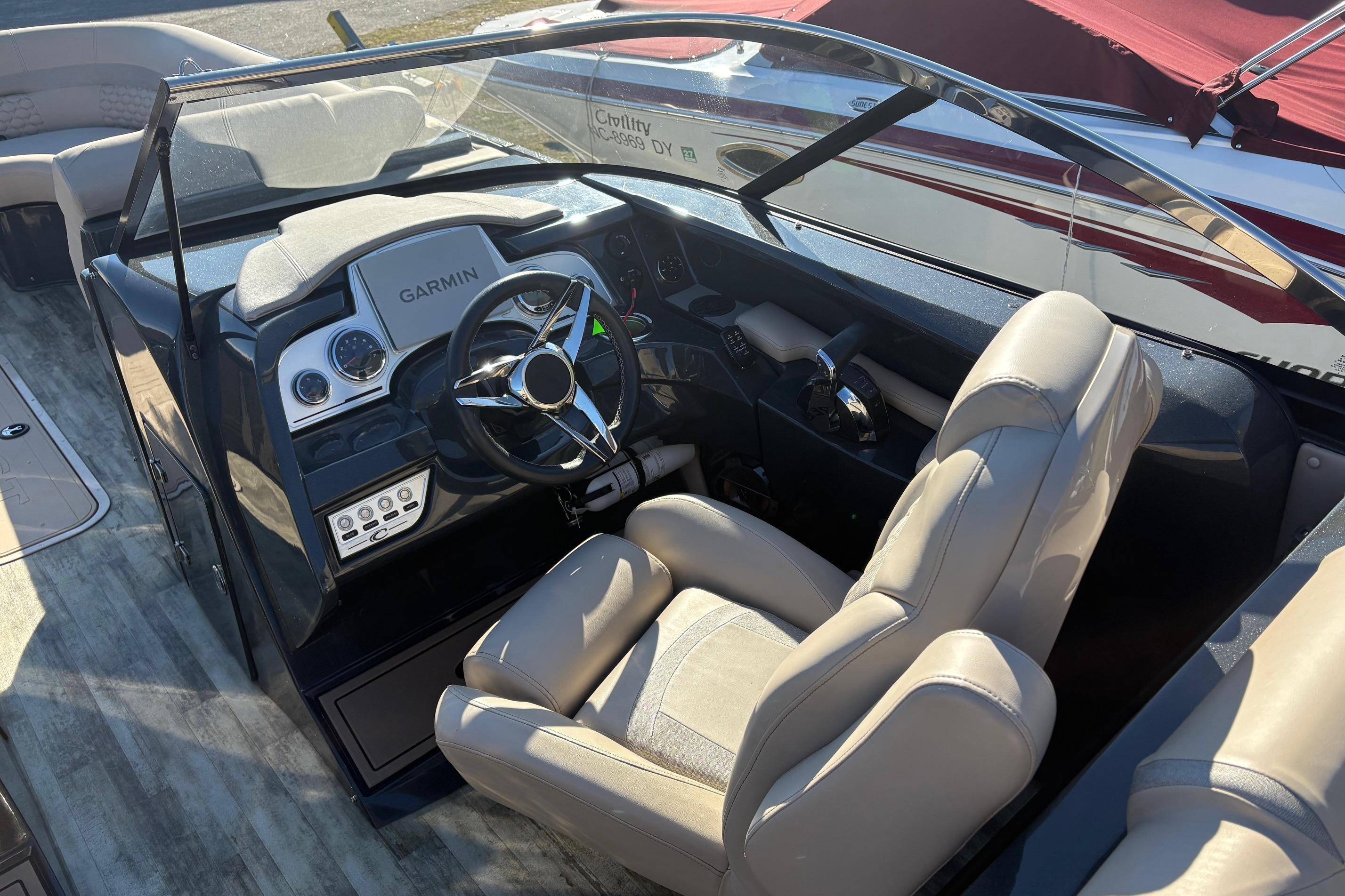 Interior of 2022 Crest Continental 250 boat with Garmin navigation system and plush seating.