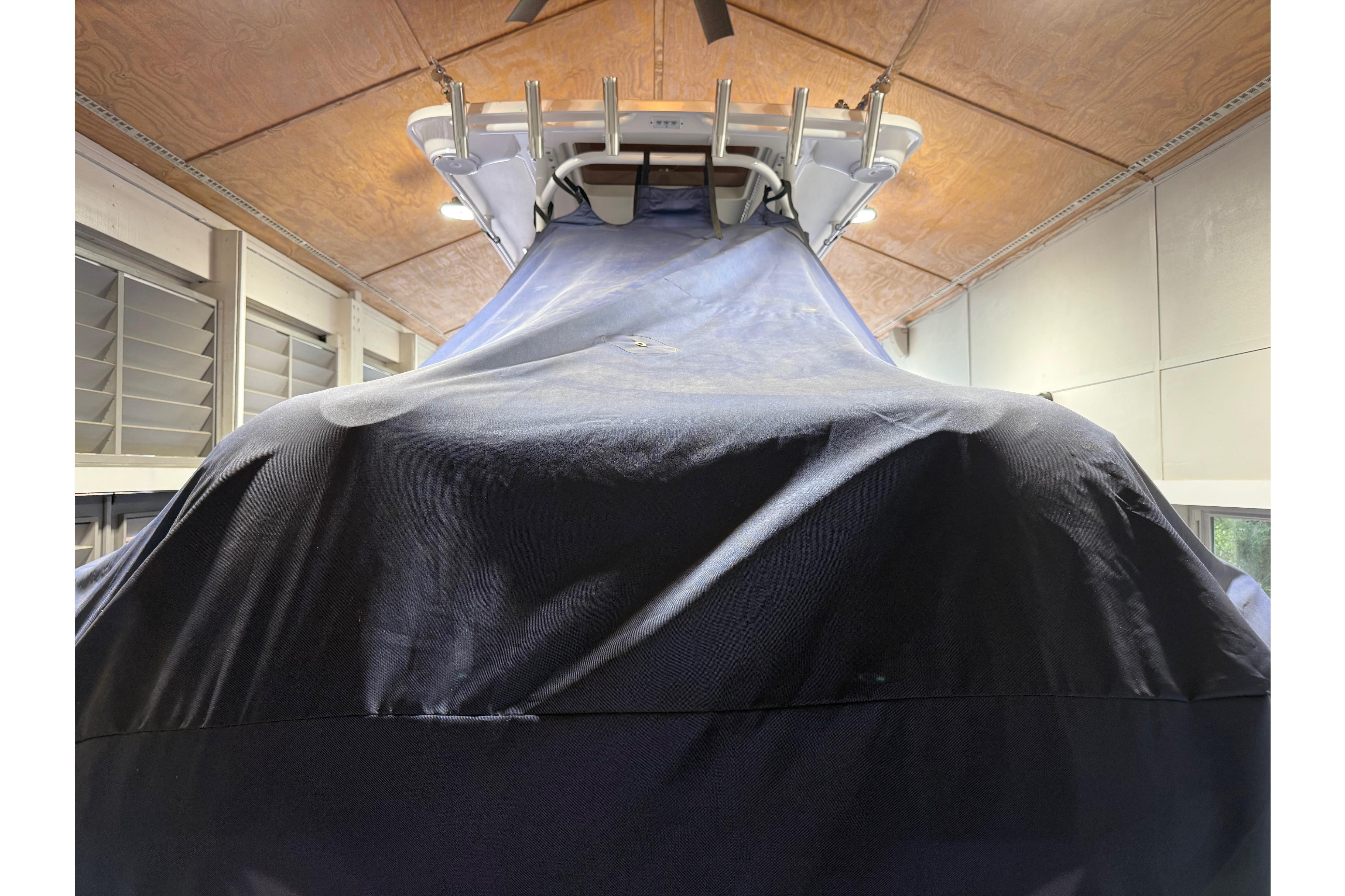 Covered 2022 Edgewater 280CC boat in indoor storage facility.