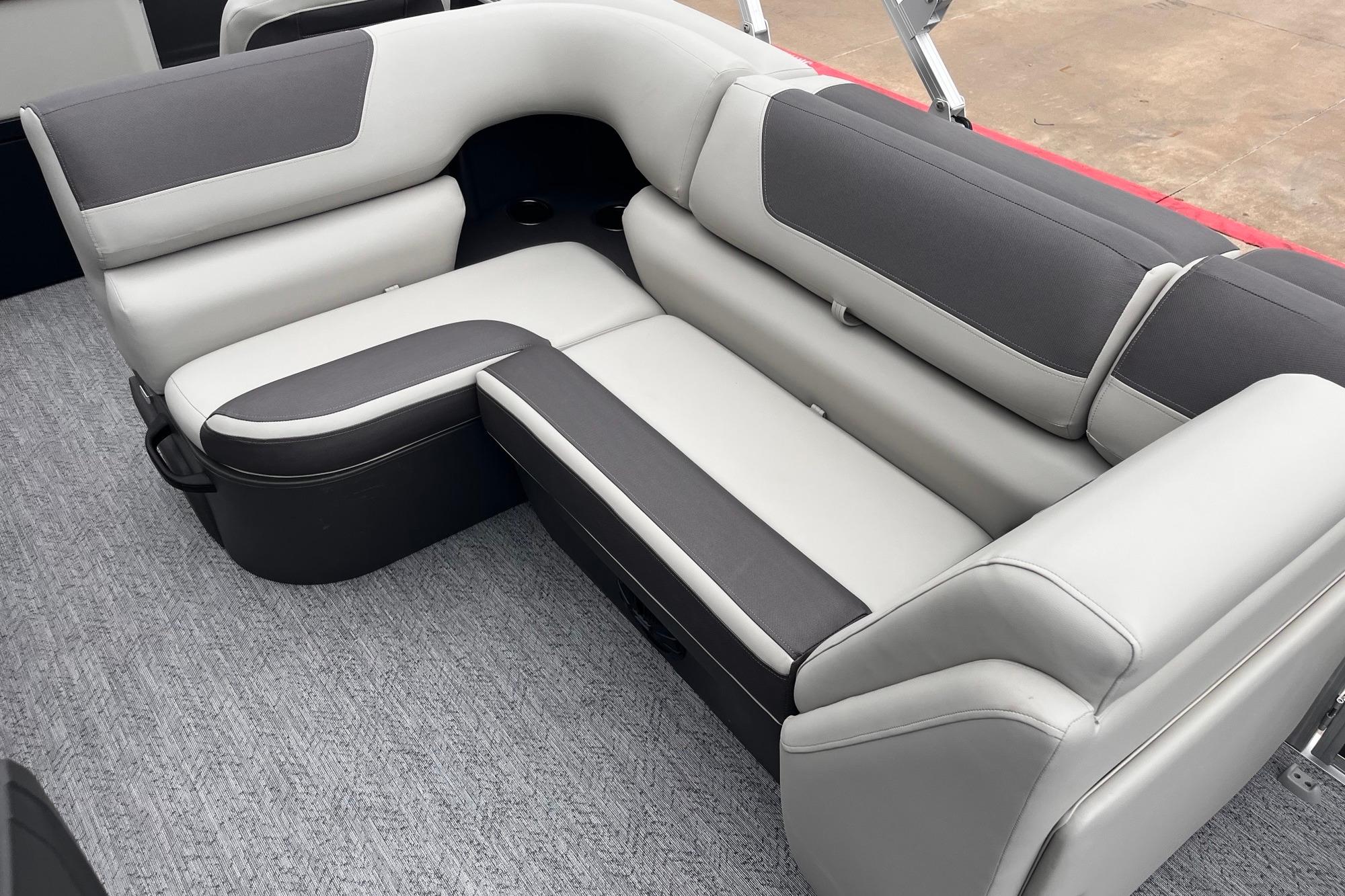 2026 Sun Tracker Fishin' Barge 20 DLX interior seating, featuring gray and white upholstery.