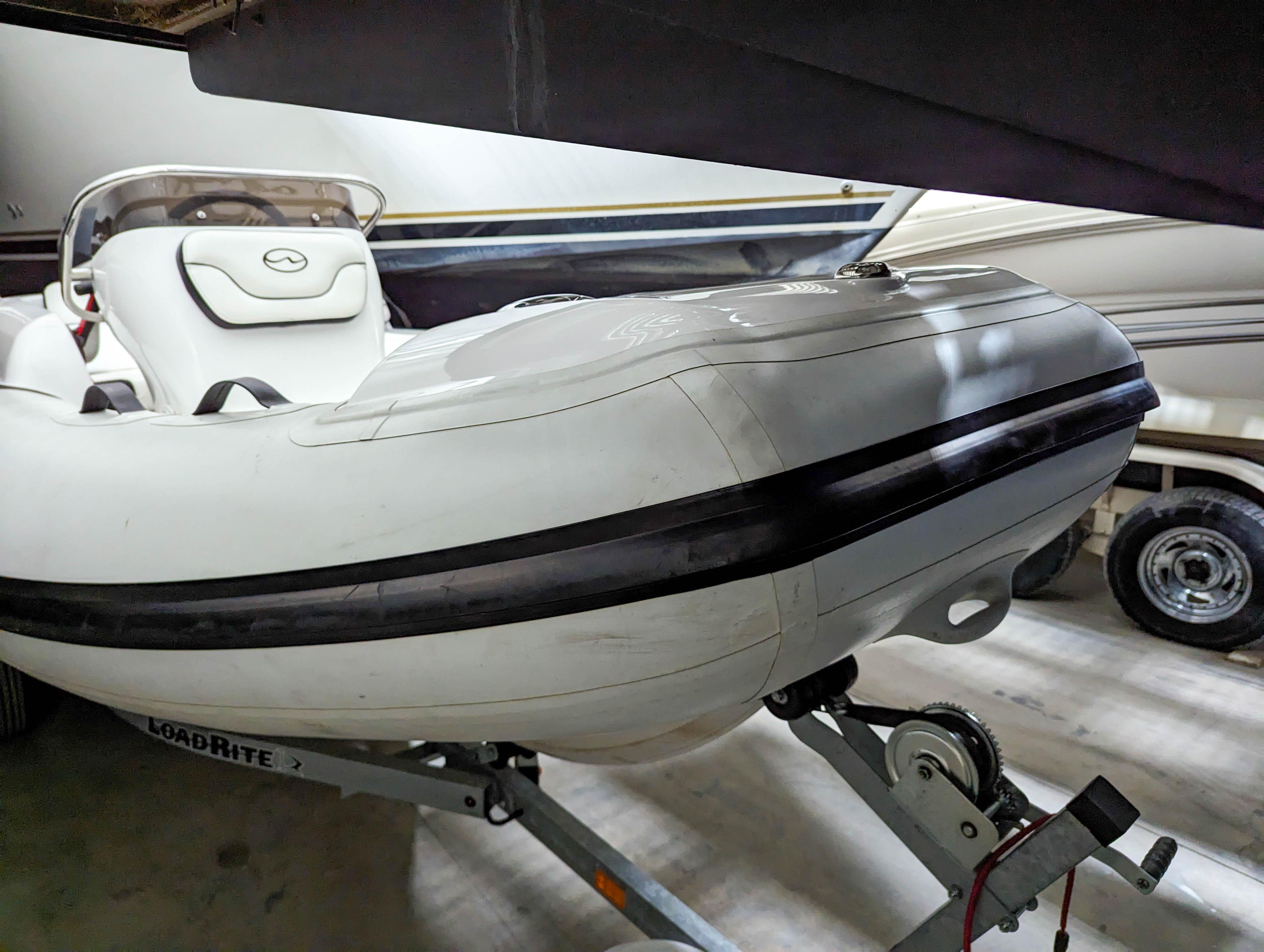 2022 Walker Bay Generation 400 inflatable boat on trailer in storage.
