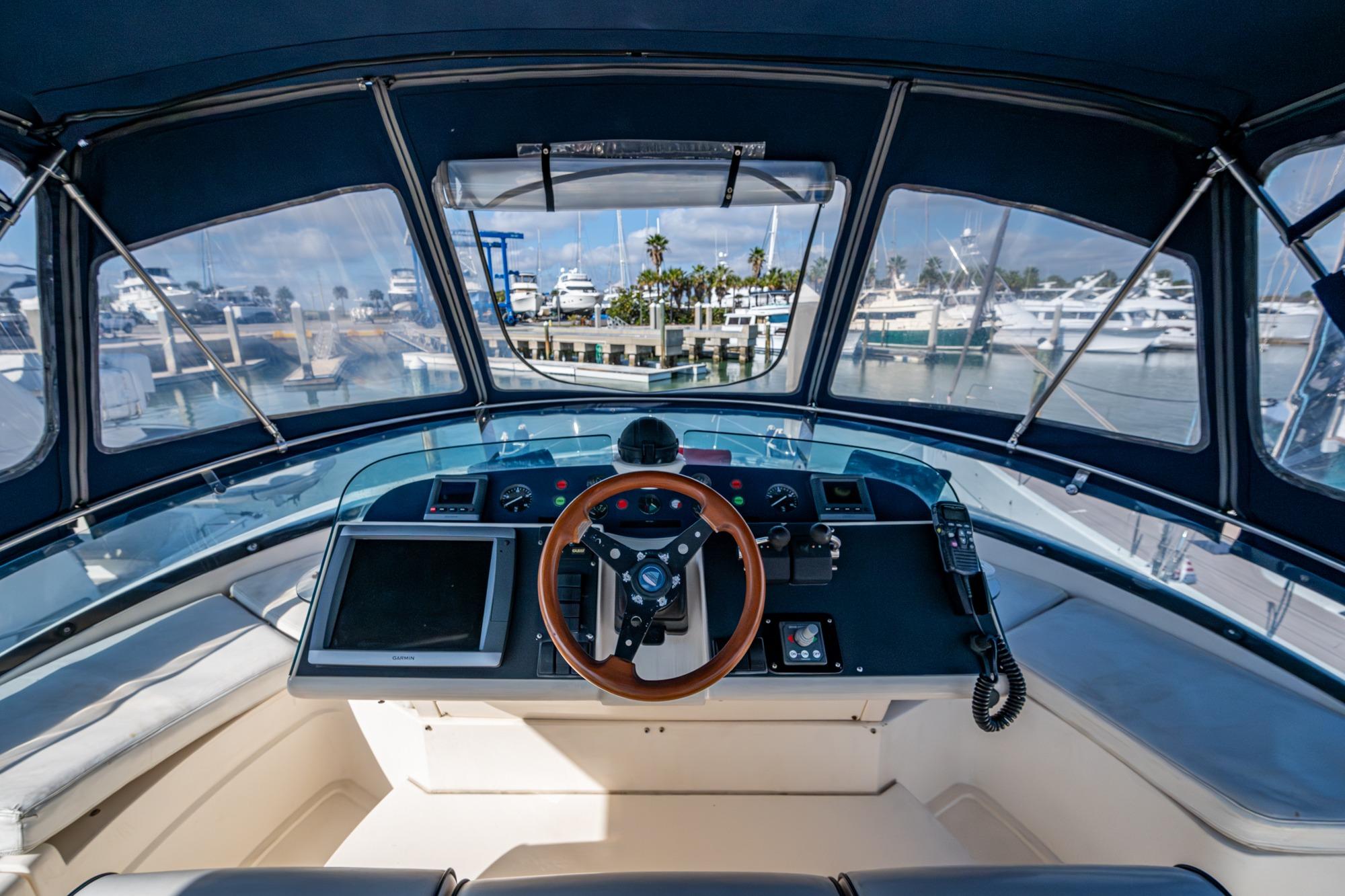 Helm of 2000 Fairline Squadron 52 yacht with marina view.