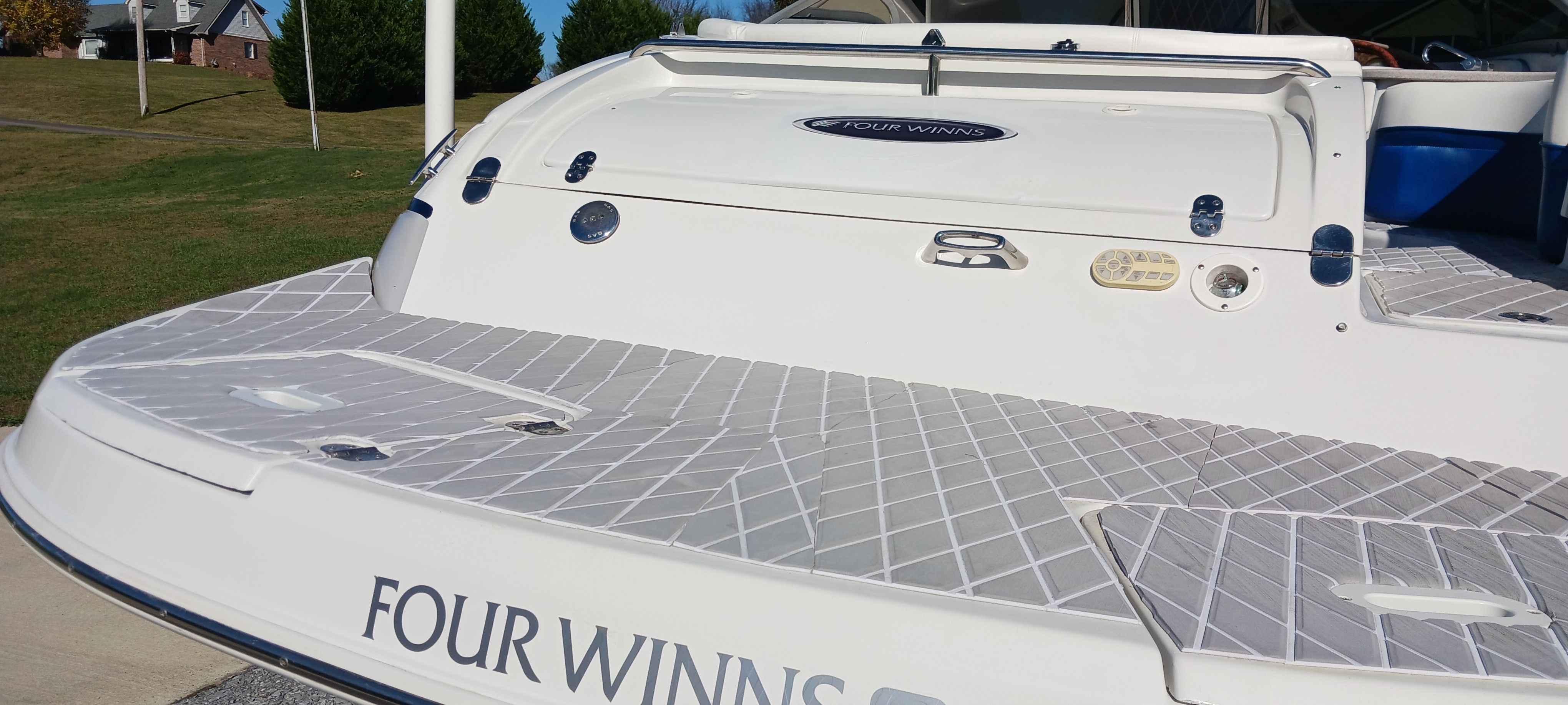 2003 Four Winns 205 Sundowner boat with spacious deck and sleek design.