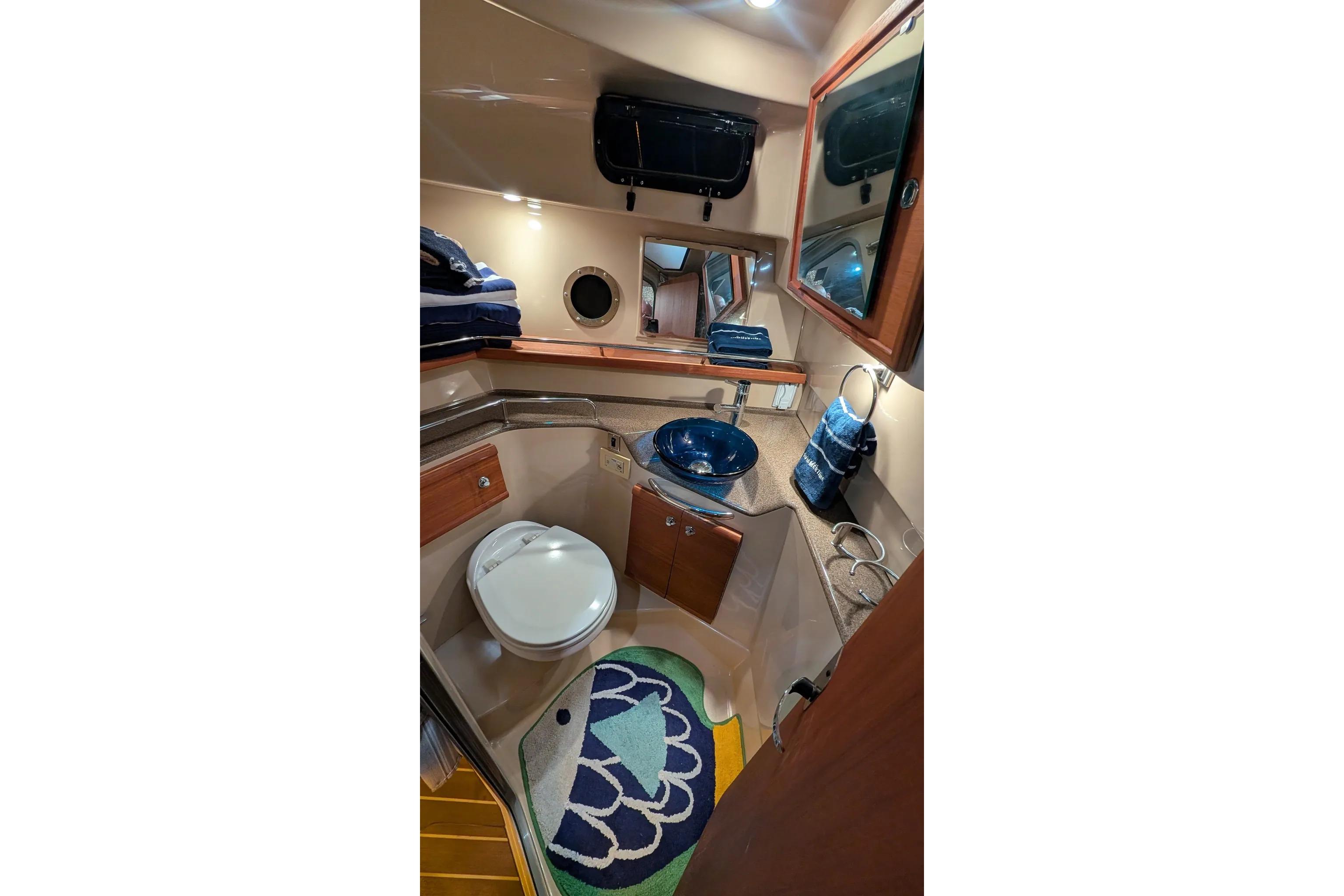 2015 Ranger Tugs R-29 S bathroom interior with modern fixtures and nautical decor.