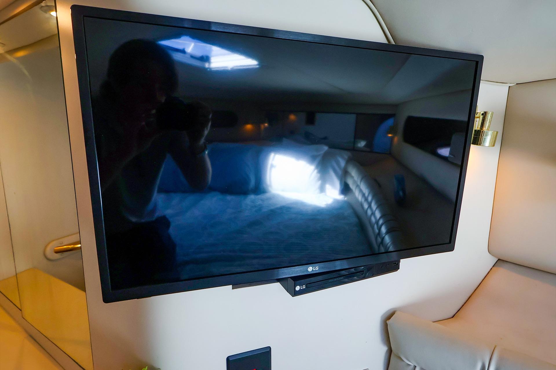 LG TV inside 1998 Sea Ray 500 Sundancer yacht cabin, reflecting interior.