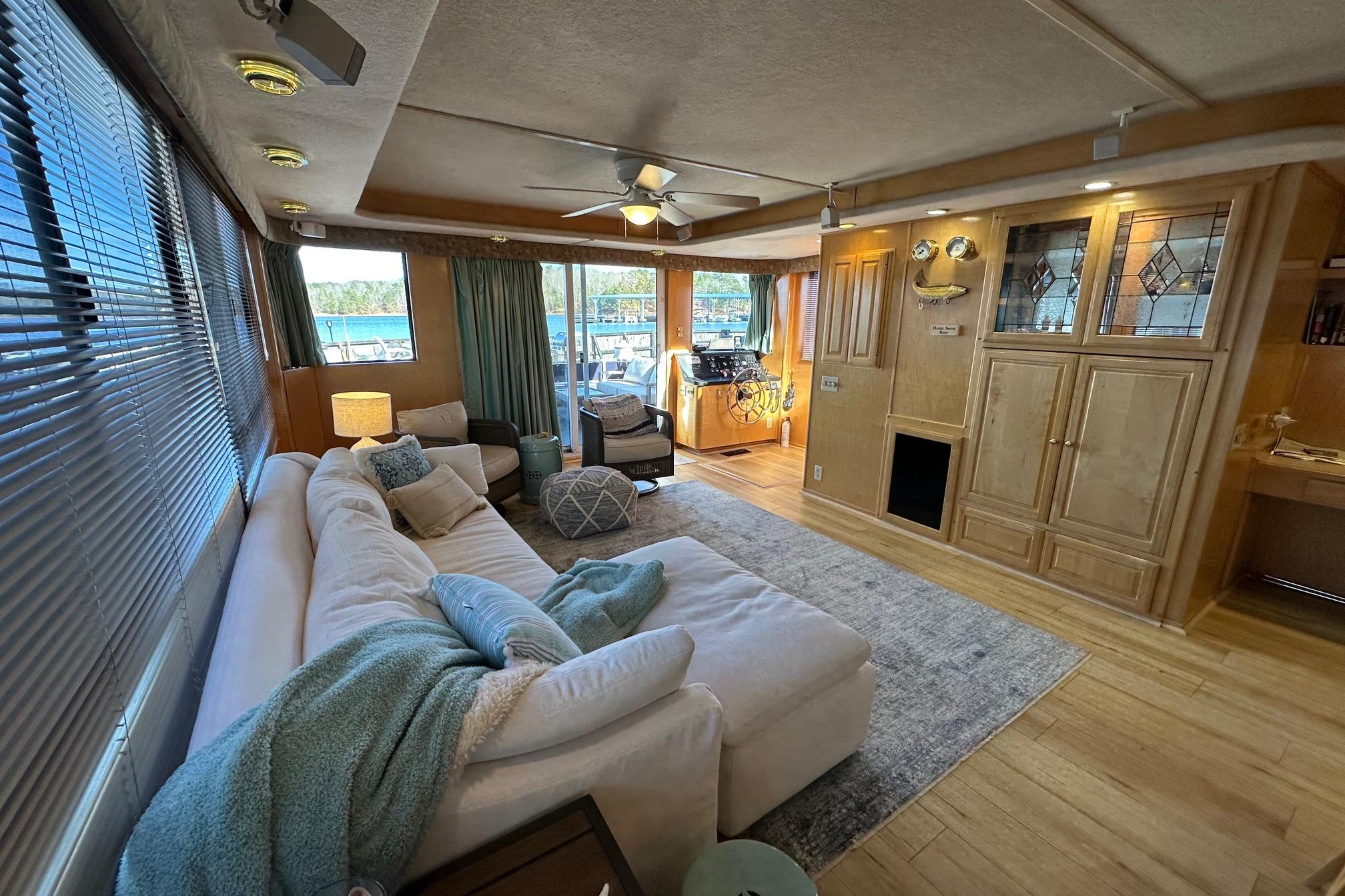 Luxurious 2000 Sumerset 16x73 houseboat interior with cozy seating and elegant wood cabinetry.
